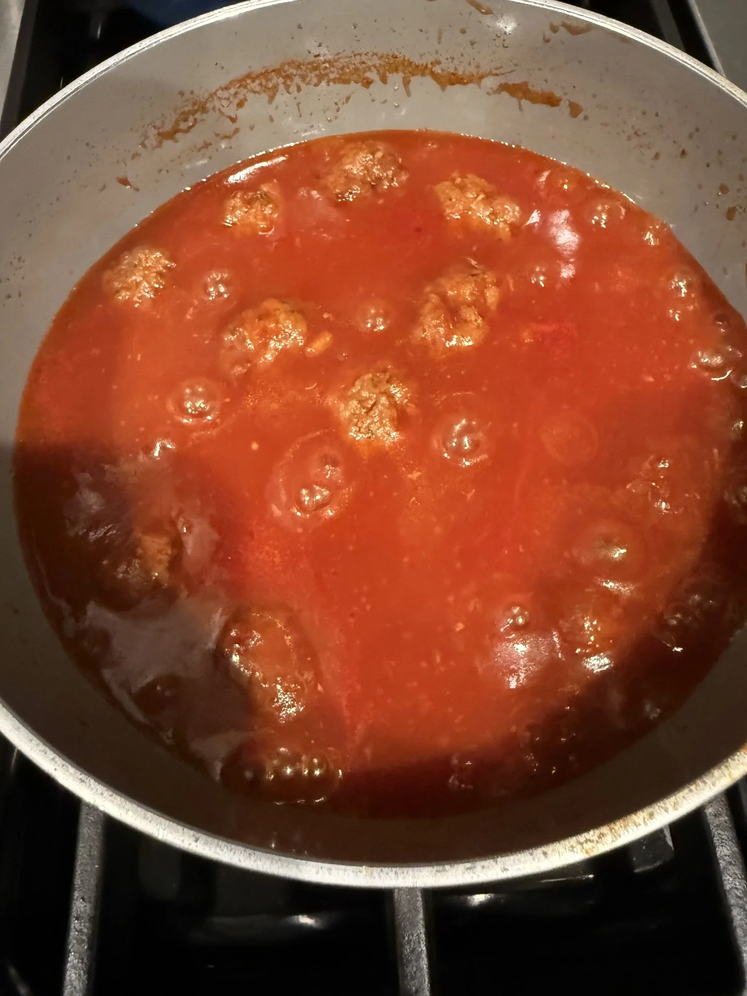 sweet and sour meatballs simmering in pot