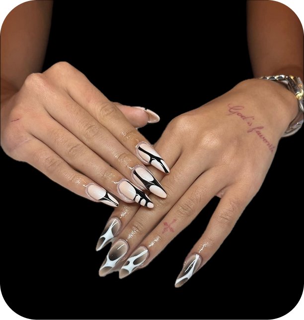 Hands with elaborately designed white and black acrylic nails, glossy finish, and tattoos on the fingers and wrist, set against a black background.