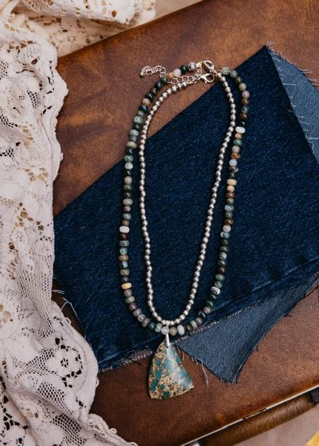 Two layered necklaces with beads and a turquoise pendant