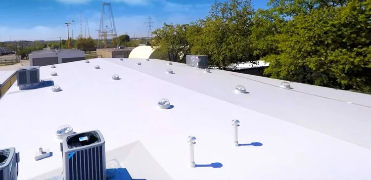 Commercial flat roof inspection on a TPO roof system
