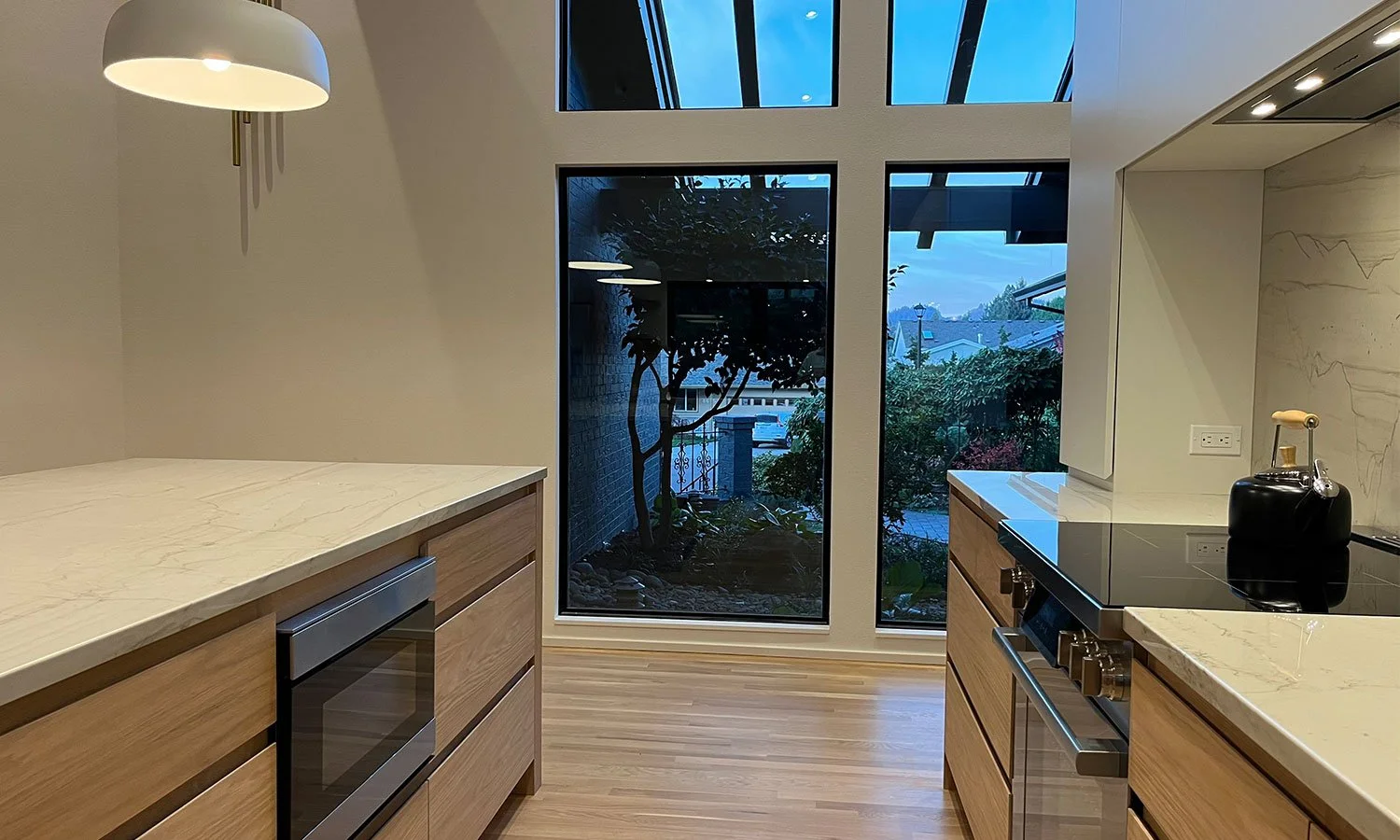 Bright kitchen with tall windows and wood floors