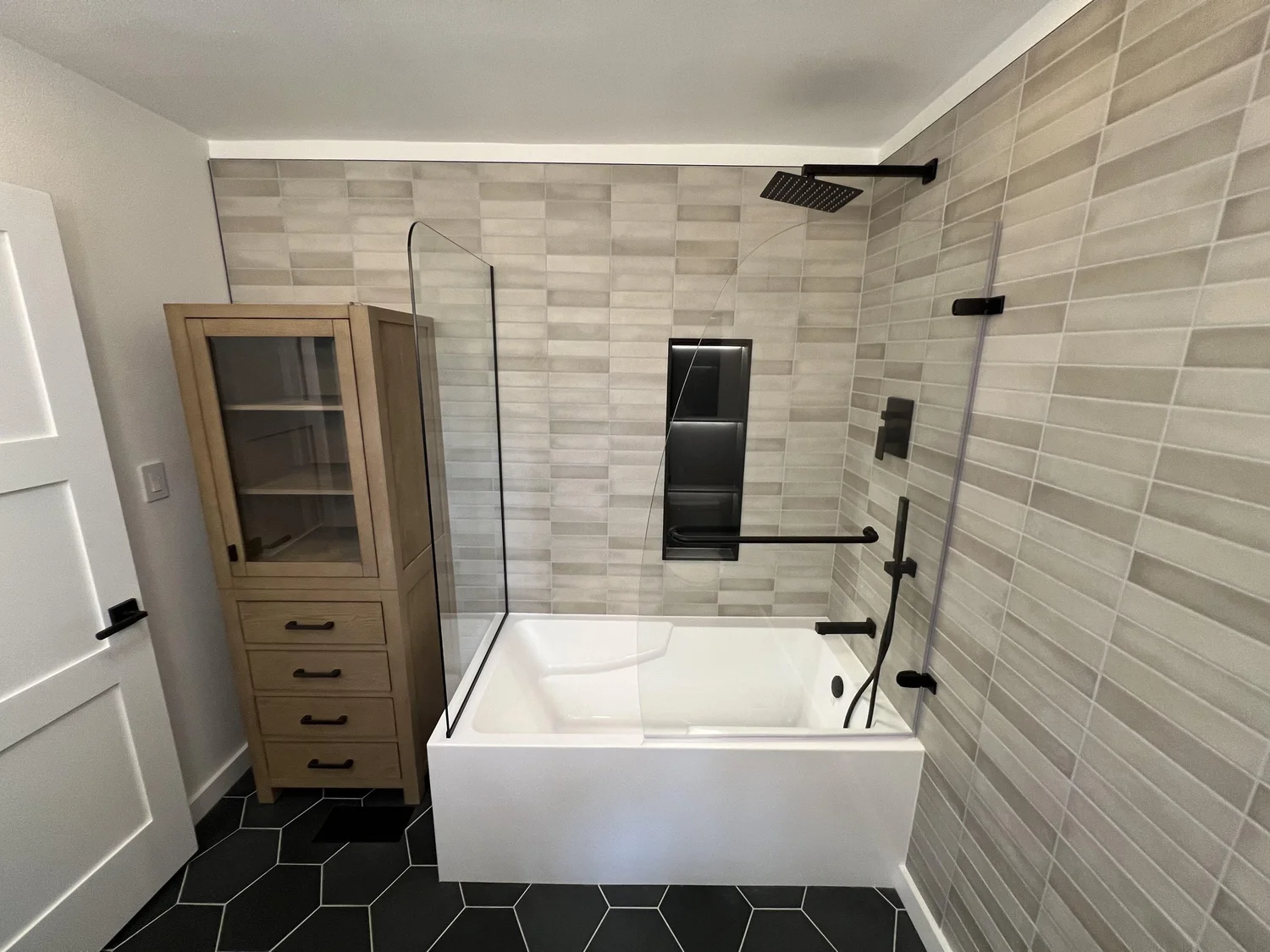 New bathroom with soaking tub, tiled shower wall and hex floor tile