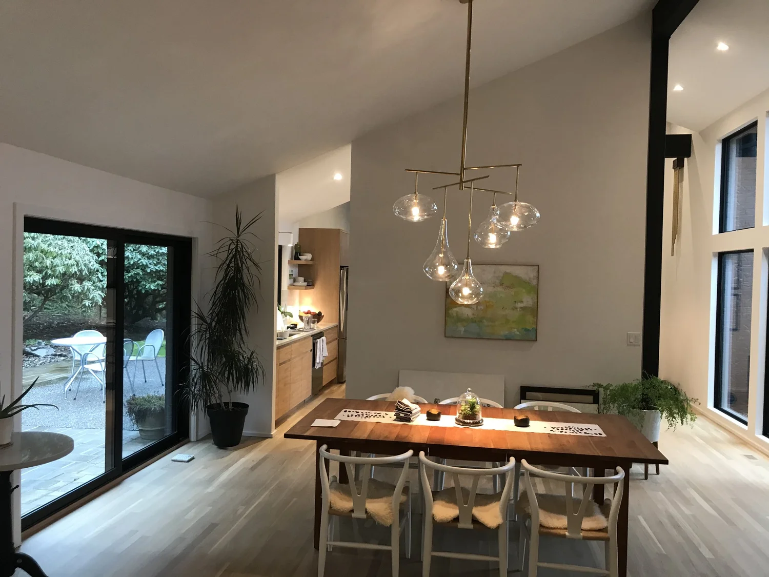 Dining room with wood table and glass pendant chandelier
