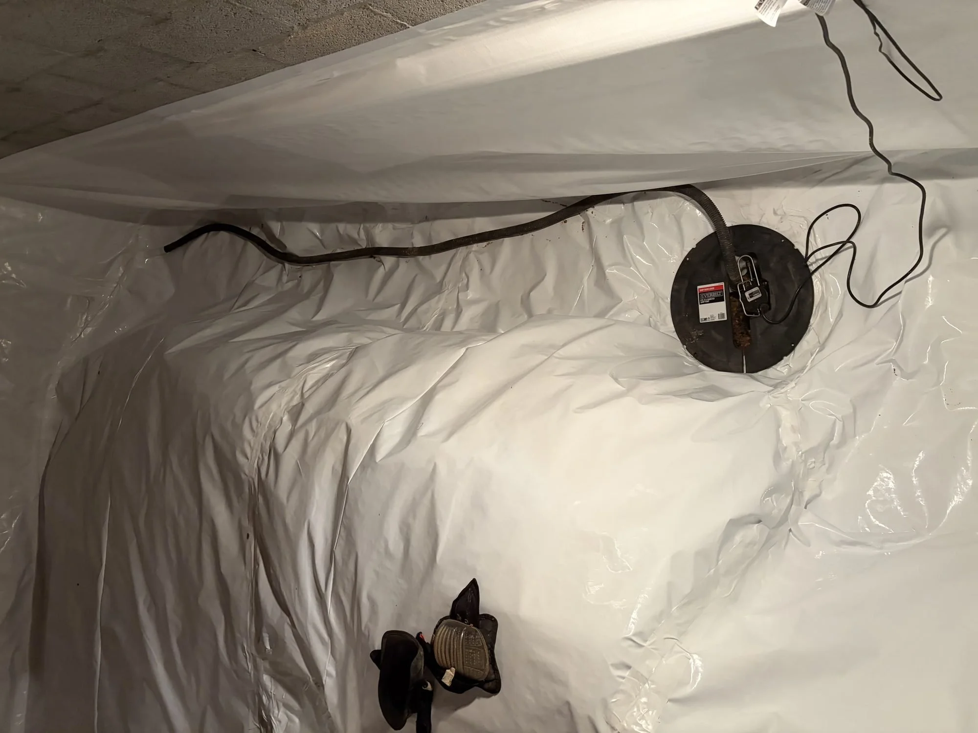 Sealed inside corner where floor and wall liner meet in an encapsulated crawl space