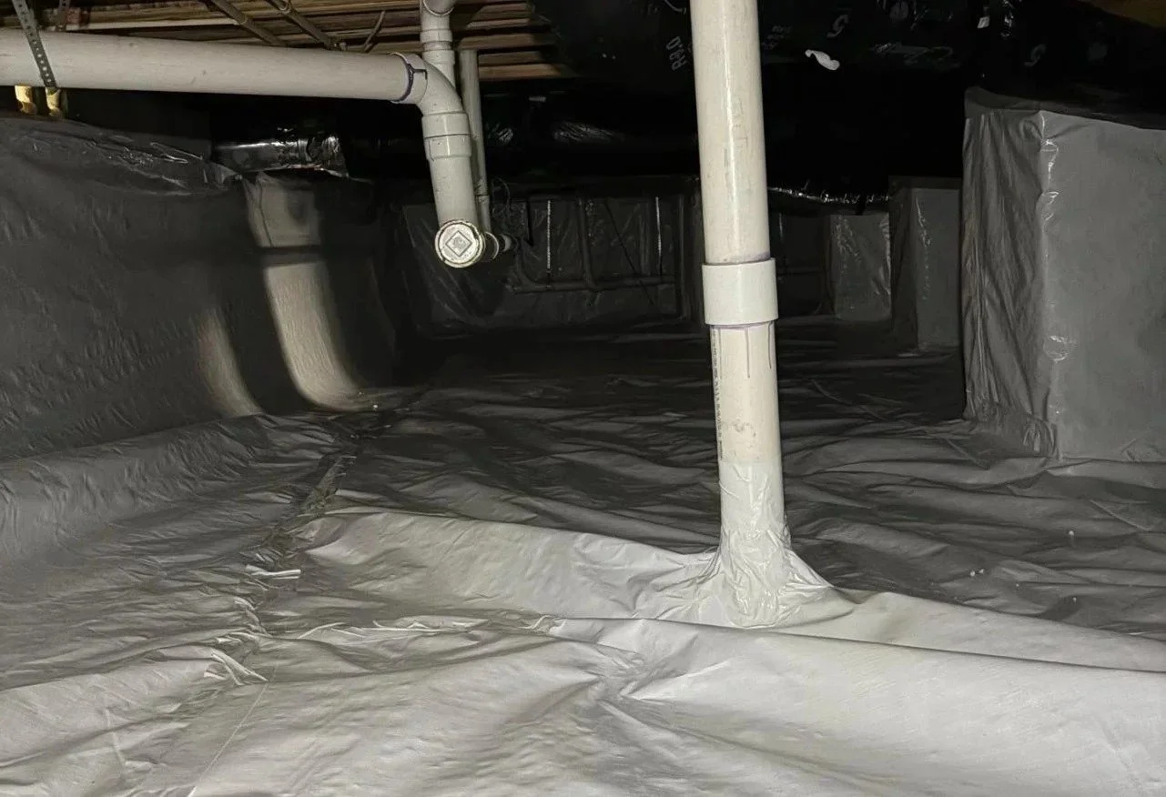 Vapor barrier sealed around crawl space plumbing — Crawlspace Crew, Murfreesboro, TN