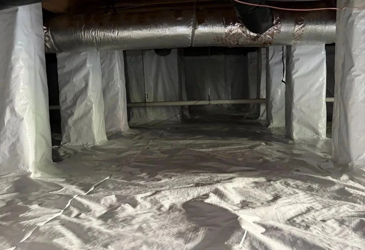 Encapsulated crawl space with sealed vapor barrier and wrapped ductwork — book a free inspection with Crawlspace Crew