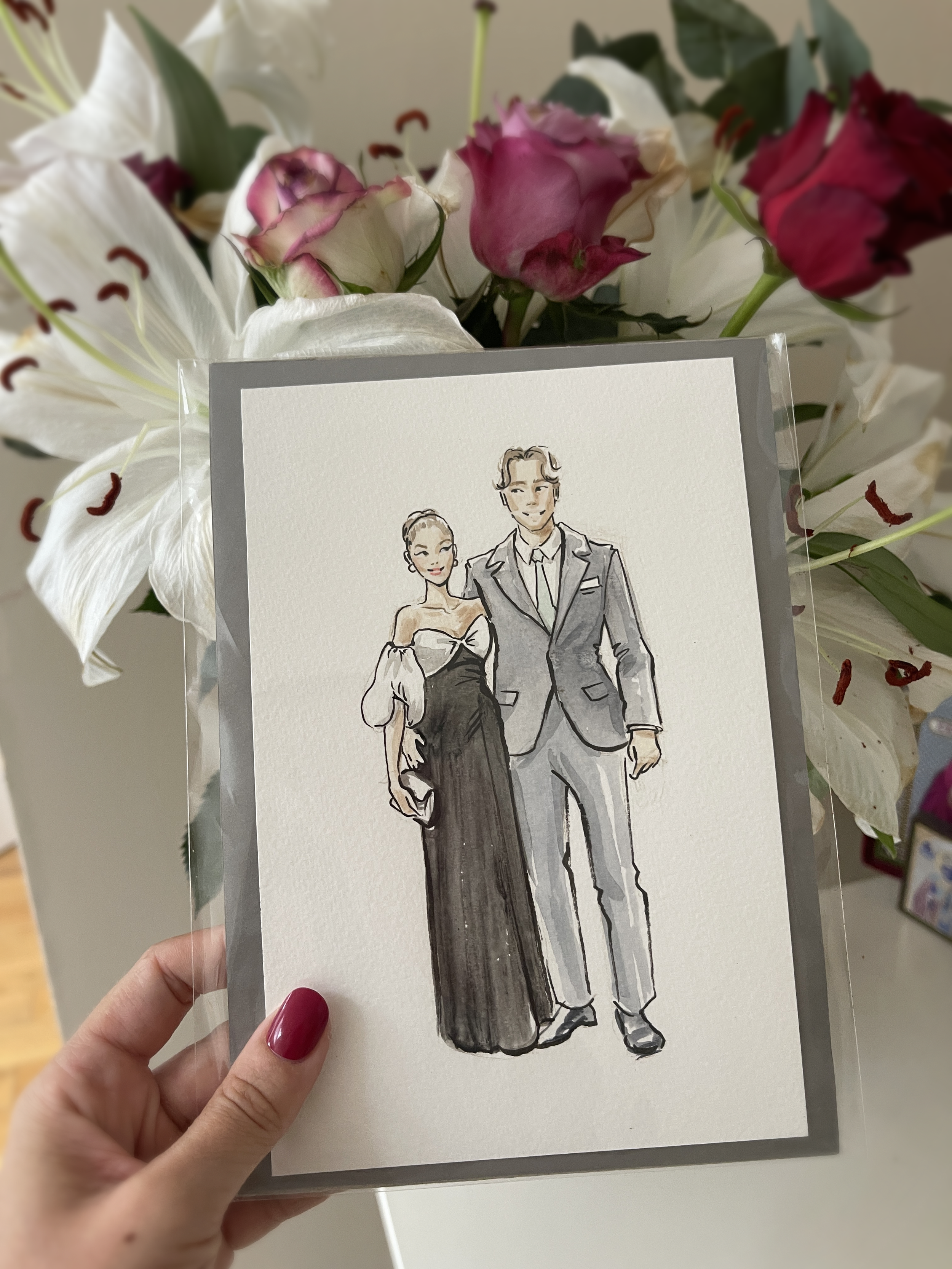 Portfolio: live wedding painting — framed watercolour couple illustration held at a wedding, bespoke portrait art by Kimberly Djehanian London