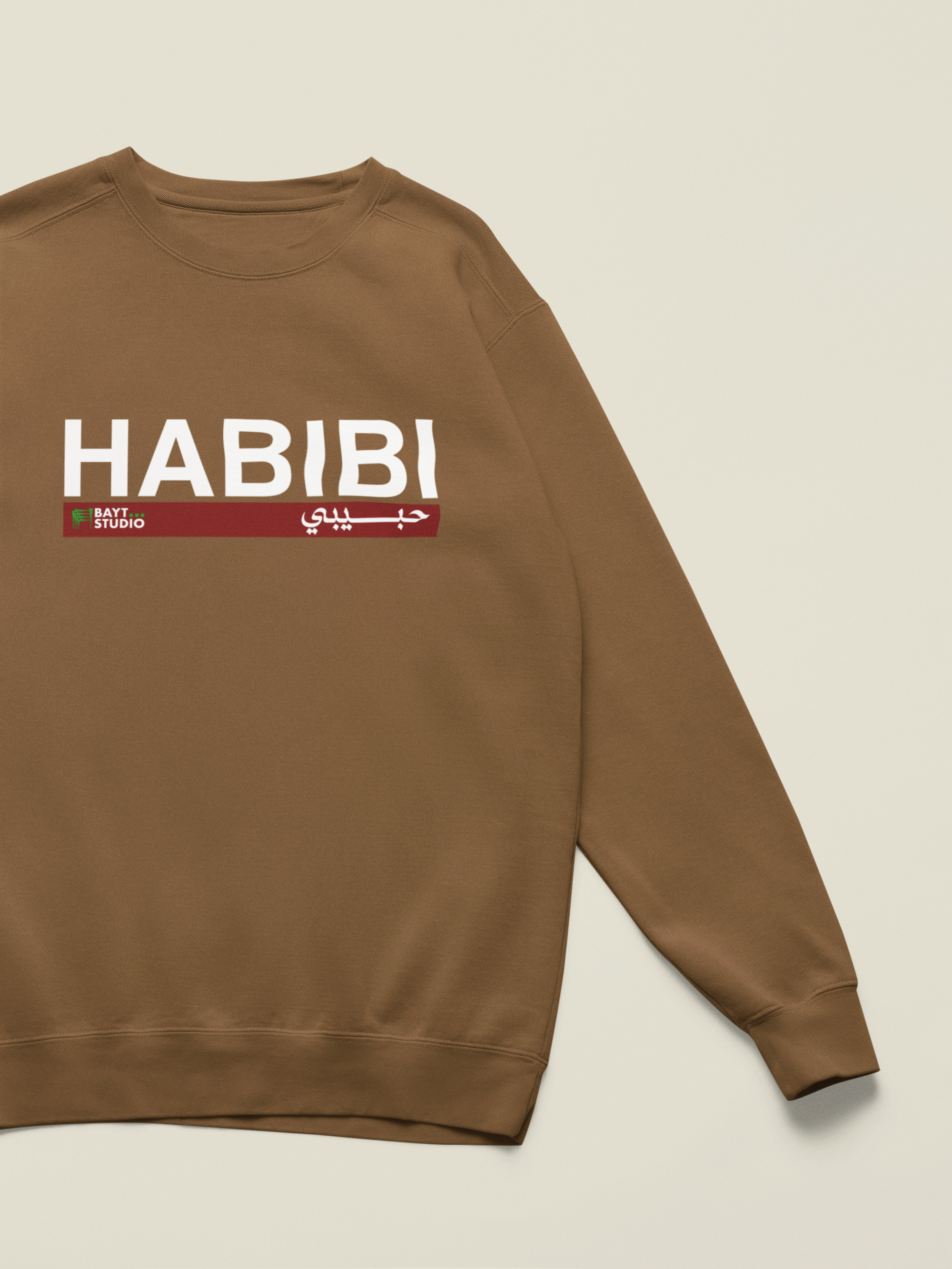 Habibi-br-sweatshirt-with-a-customizable-sleeve-lying-on-a-colorful-background-m52750 12.png