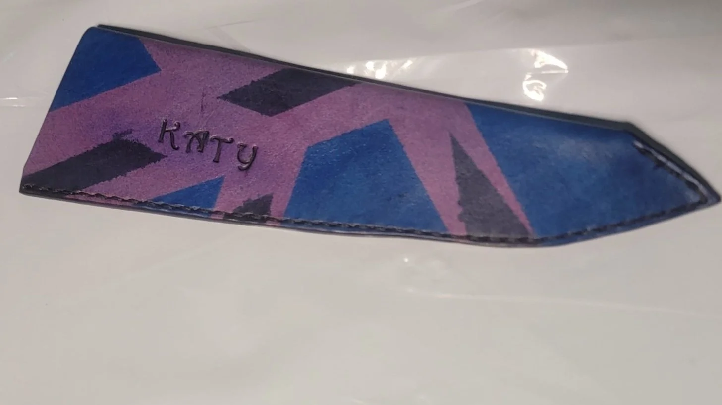 Full-size with a purple base, and separate blue and black masking.