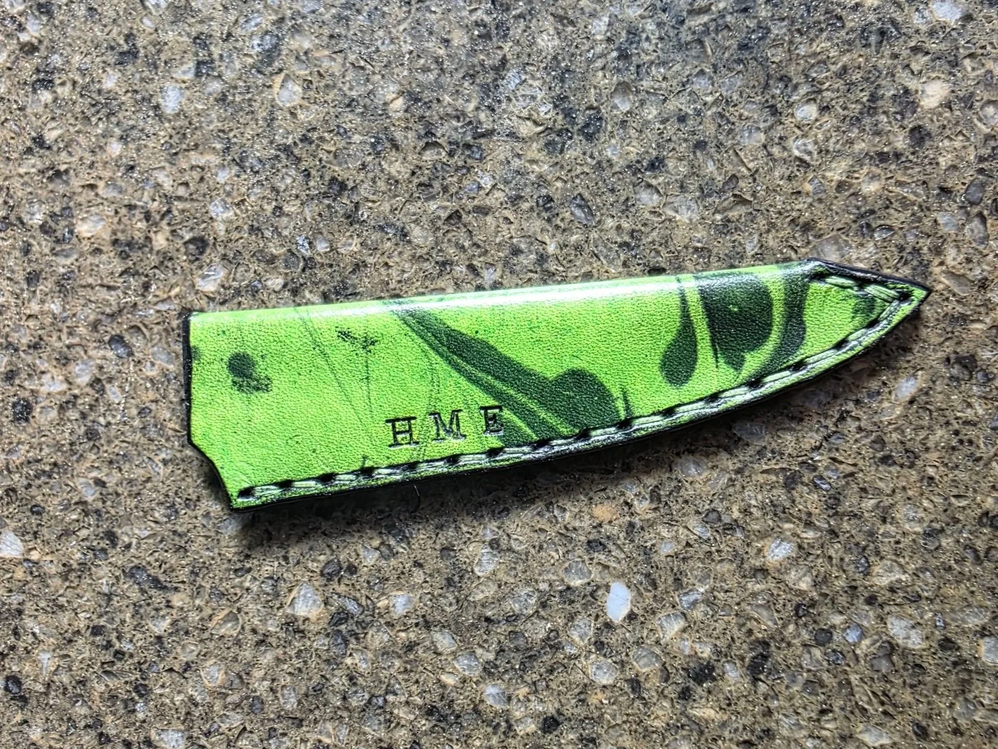 A Mini Sheath for a Pairing knife, with Bright Green base, and Black Marbling.