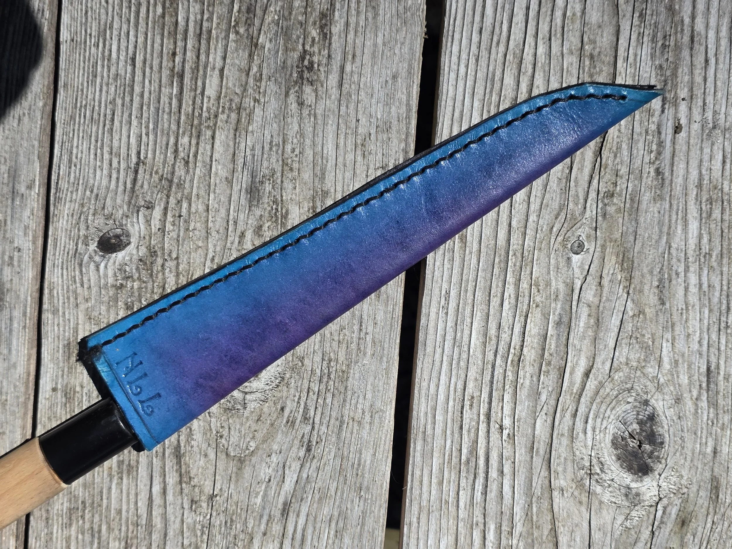 Personal Full-size single beveled slicer with a purple to blue center fade, with "NLL" stamped in.