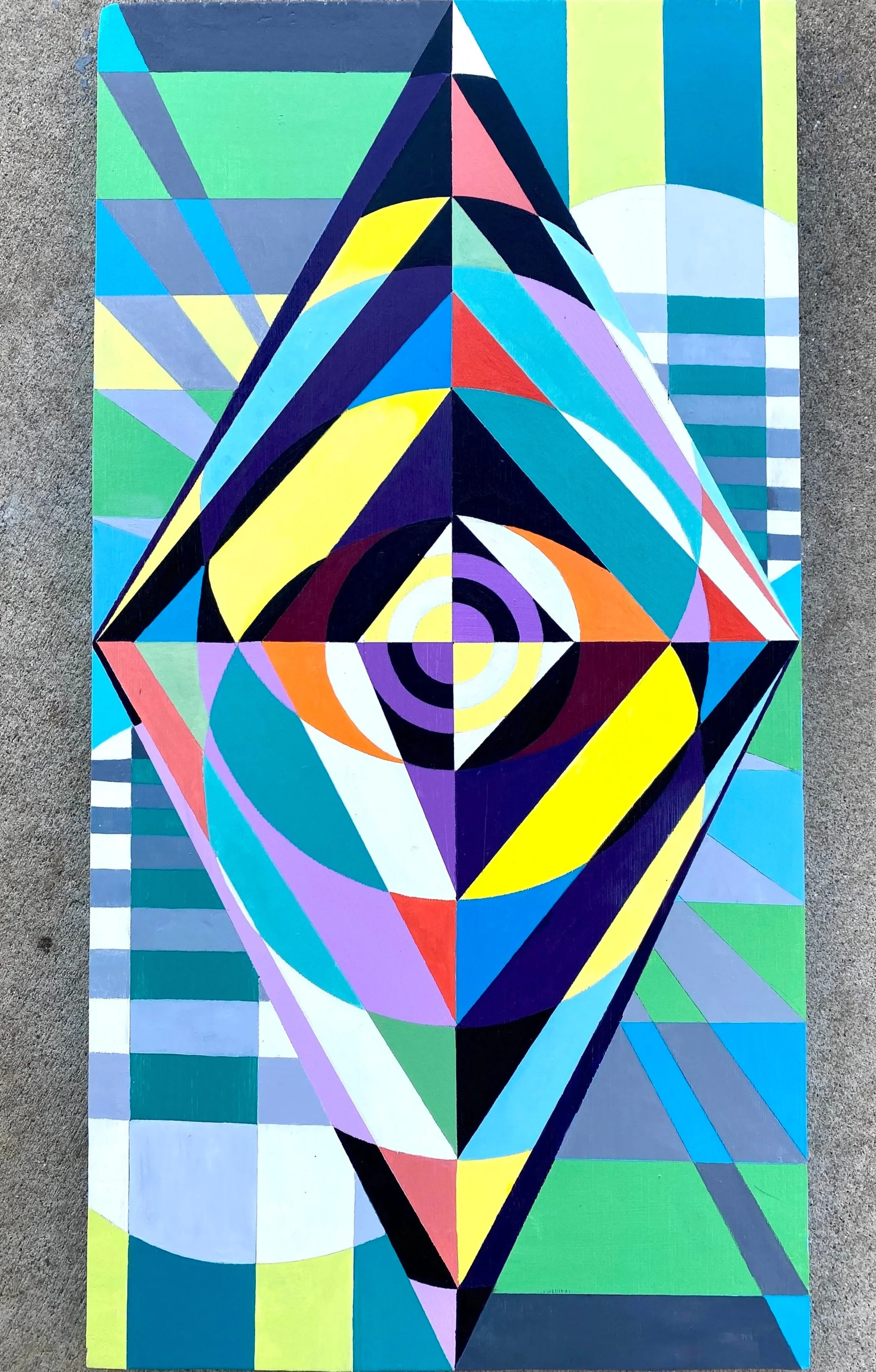 Colorful geometric abstract mural featuring a central diamond shape with concentric circles and various triangular and rectangular patterns in shades of blue, purple, yellow, red, black, white, and green.