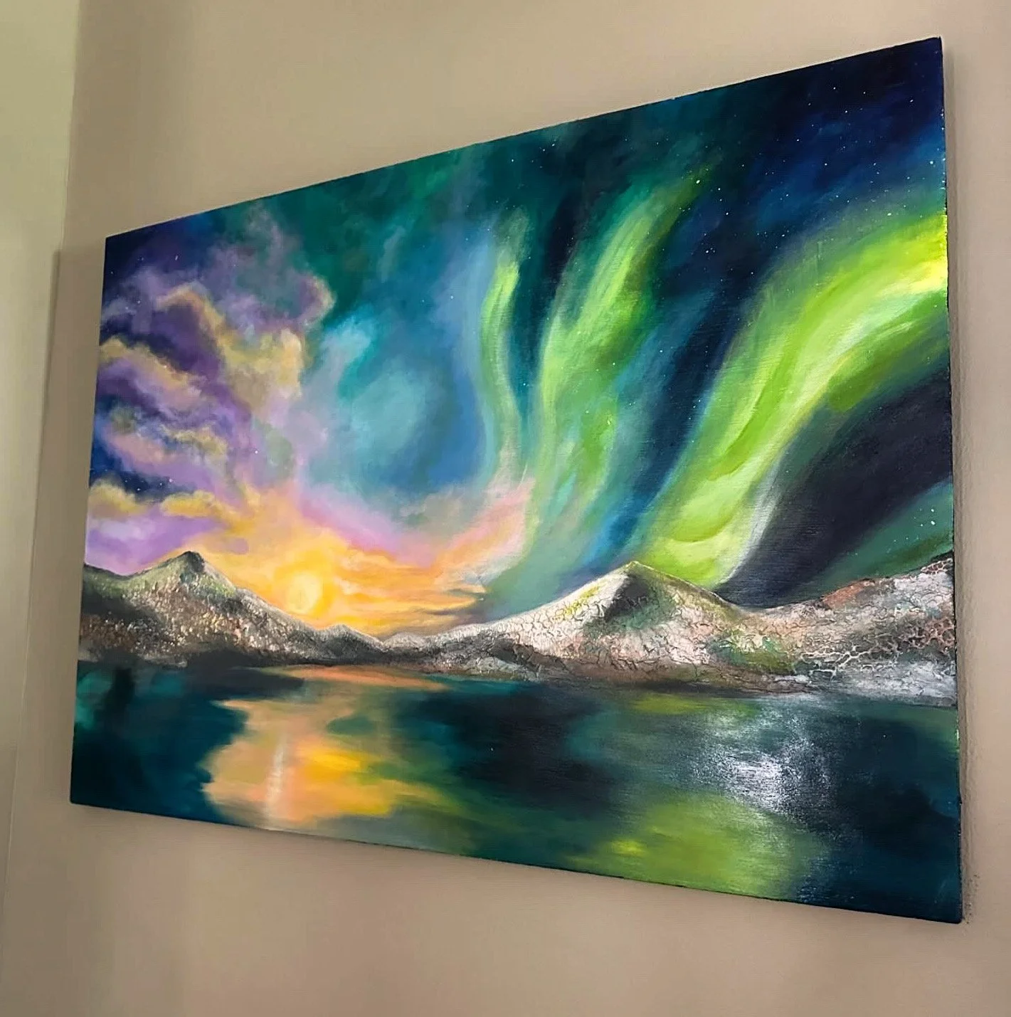 A colorful landscape painting of a mountain range reflected in a lake with a vibrant sky showing the Northern Lights, sunset, or sunrise.