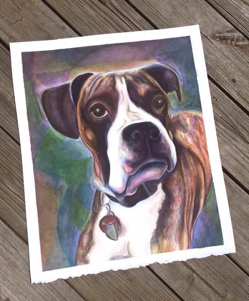 Colorful portrait painting of a dog with brown, black, and white fur, looking directly forward, on a wooden surface.