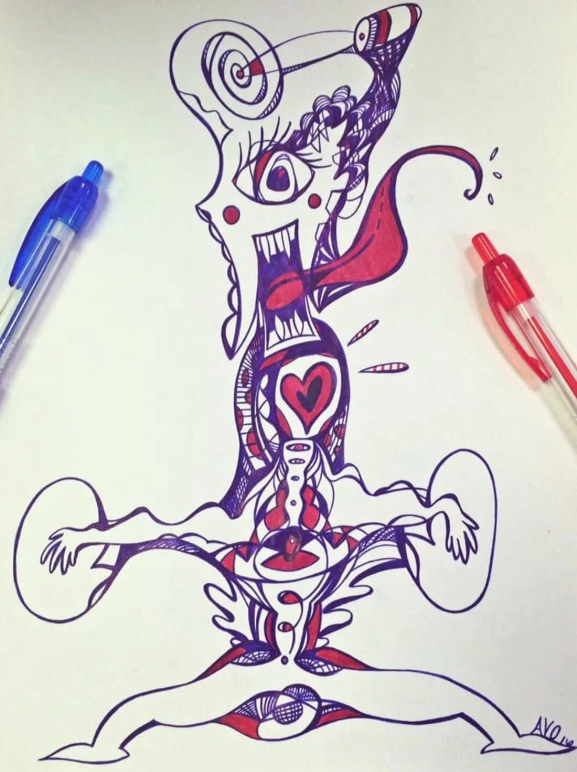 An abstract, colorful drawing of a creature with exaggerated facial features, arms spread wide, a heart symbol on its chest, and a tongue sticking out. The drawing is made with purple and red ink pens, with two pens placed on either side of the artwo