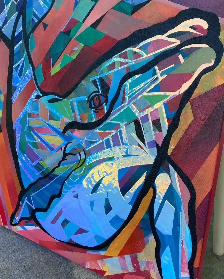 Abstract painting of a butterfly with bold outlines and vibrant colors, featuring geometric shapes and a mix of blue, yellow, red, and green hues.