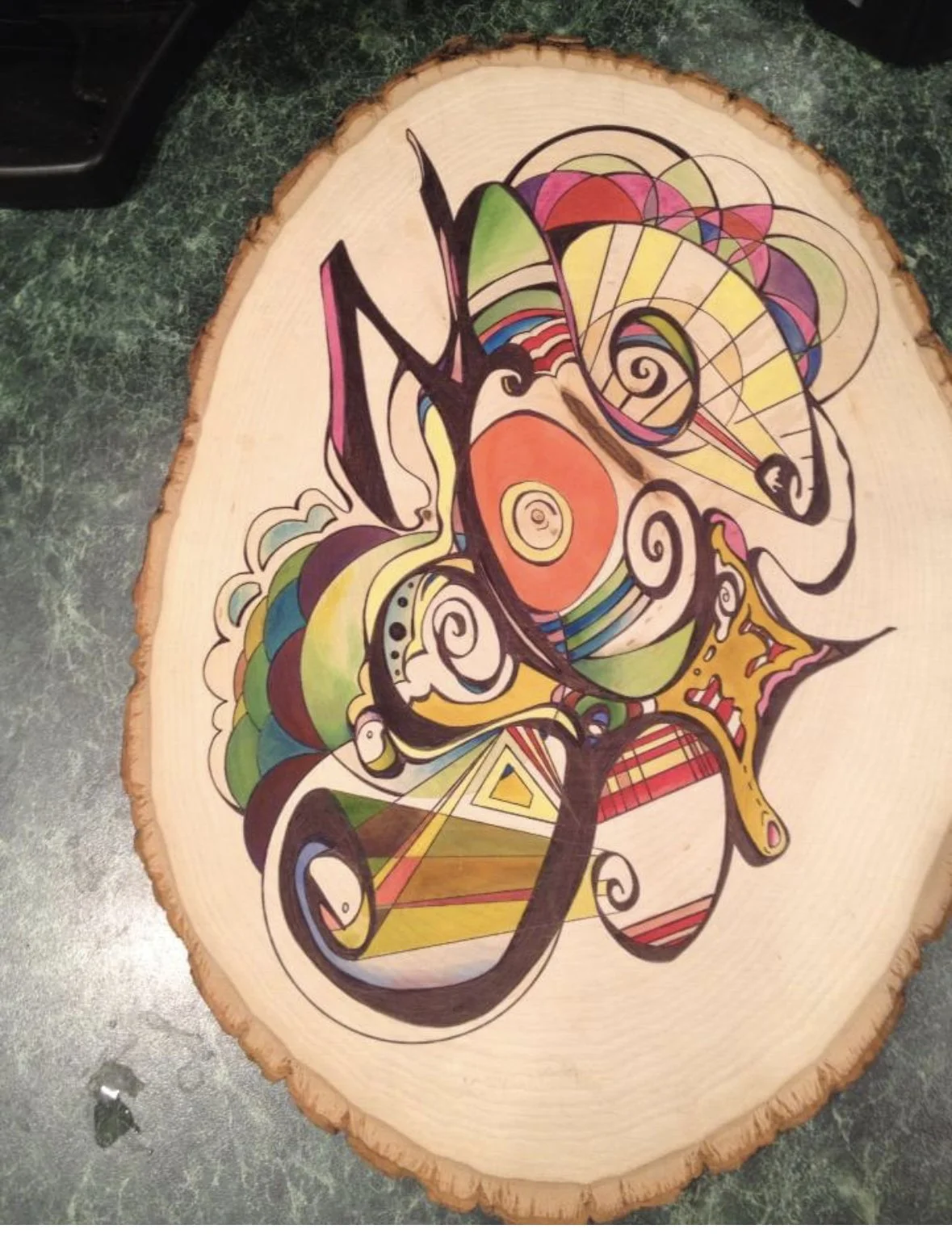 Colorful abstract painting on a wooden slab with swirling and geometric patterns.