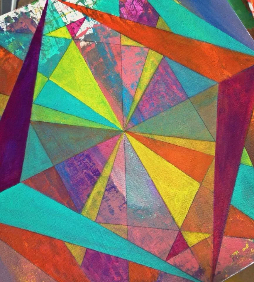 Colorful geometric abstract art with various triangles and shapes in bright colors like yellow, orange, pink, purple, blue, and green.