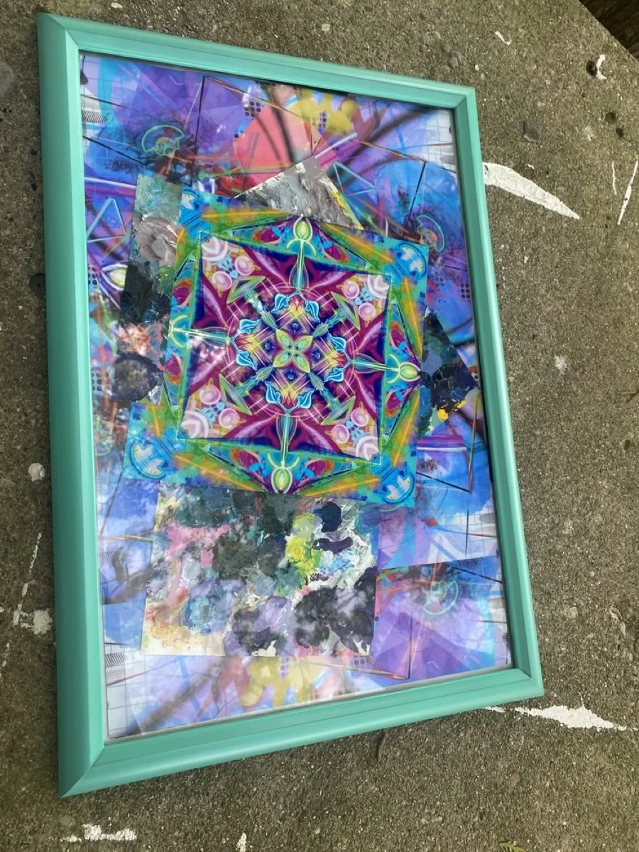 Colorful geometric artwork with bright neon colors and patterns, framed in a turquoise frame, laid on a rough concrete ground.