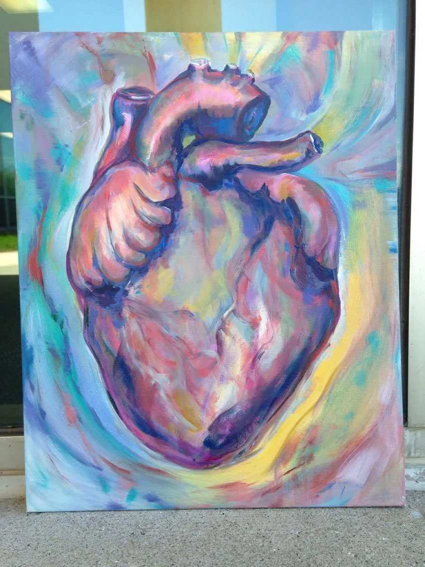 Colorful painting of a human heart with a hand making a thumbs-up gesture, using vibrant shades of pink, purple, blue, and yellow.