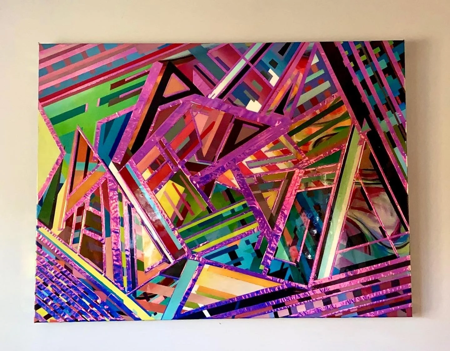 Colorful abstract artwork with intersecting geometric shapes and lines in pink, purple, green, blue, and yellow on a canvas.