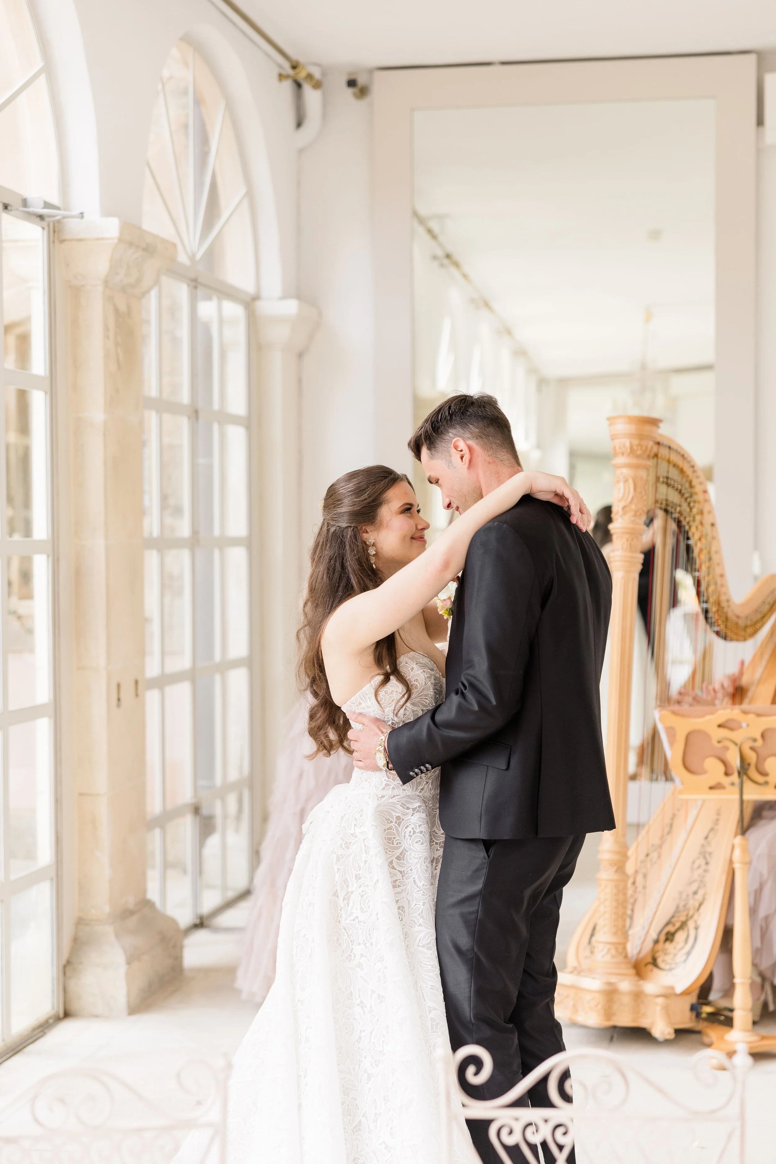 Intimate bridal couple portrait with a kiss in an elegant and warm wedding environment.