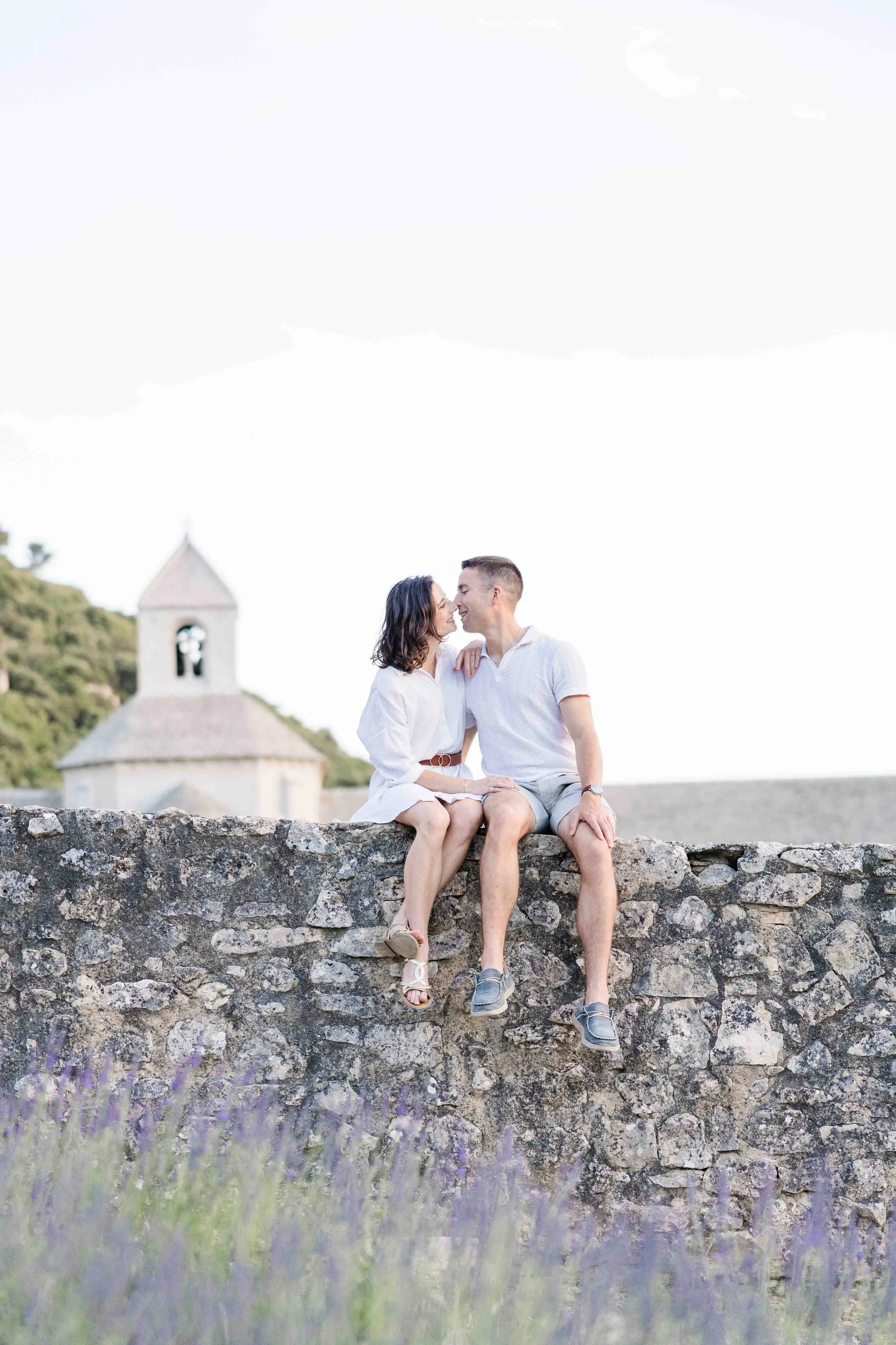 Couple Sitting on Stone Wall at Sénanque Abbey
