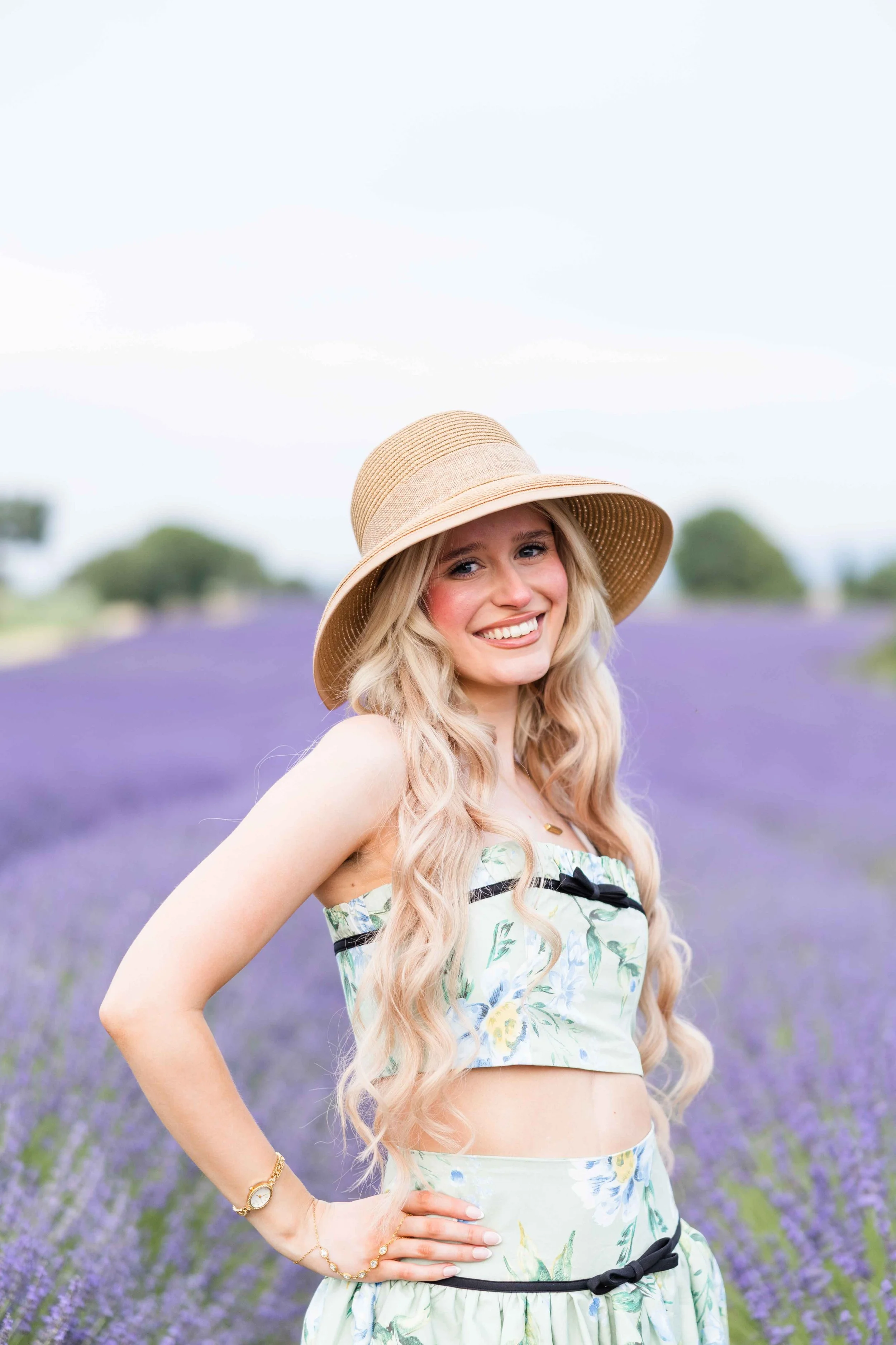  Blonde woman smiling in a lavender field during a portrait session in Provence. 