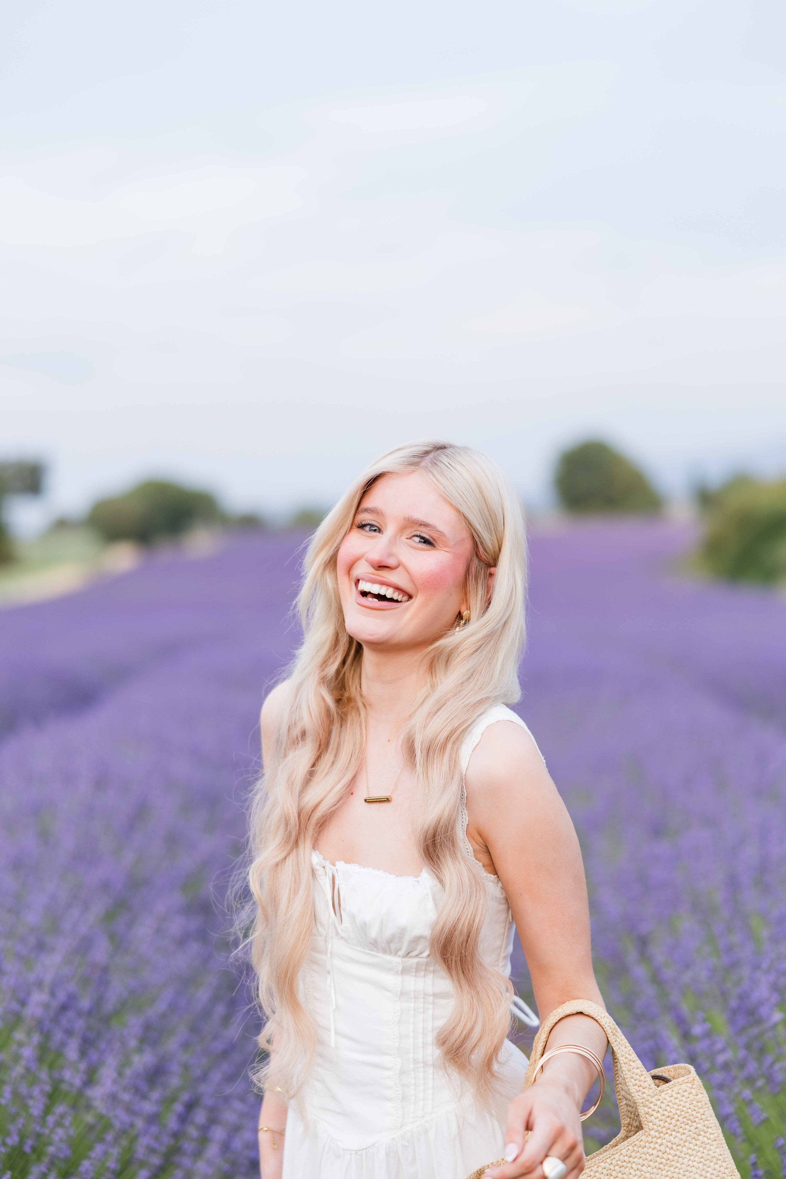  Close portrait of a smiling woman in blooming lavender fields in Provence, France. 