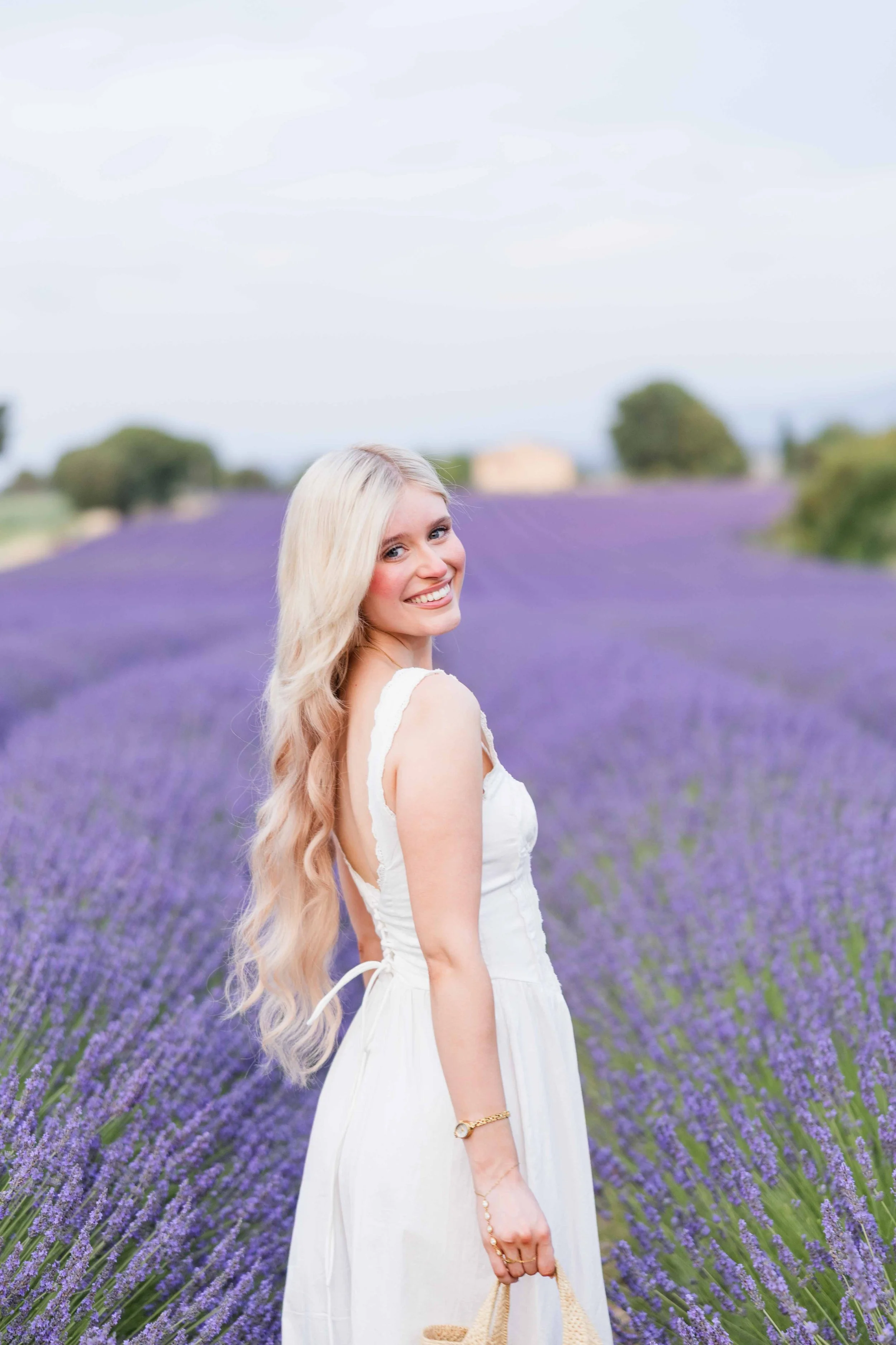  Woman smiling in lavender fields during a romantic photoshoot in Provence. 
