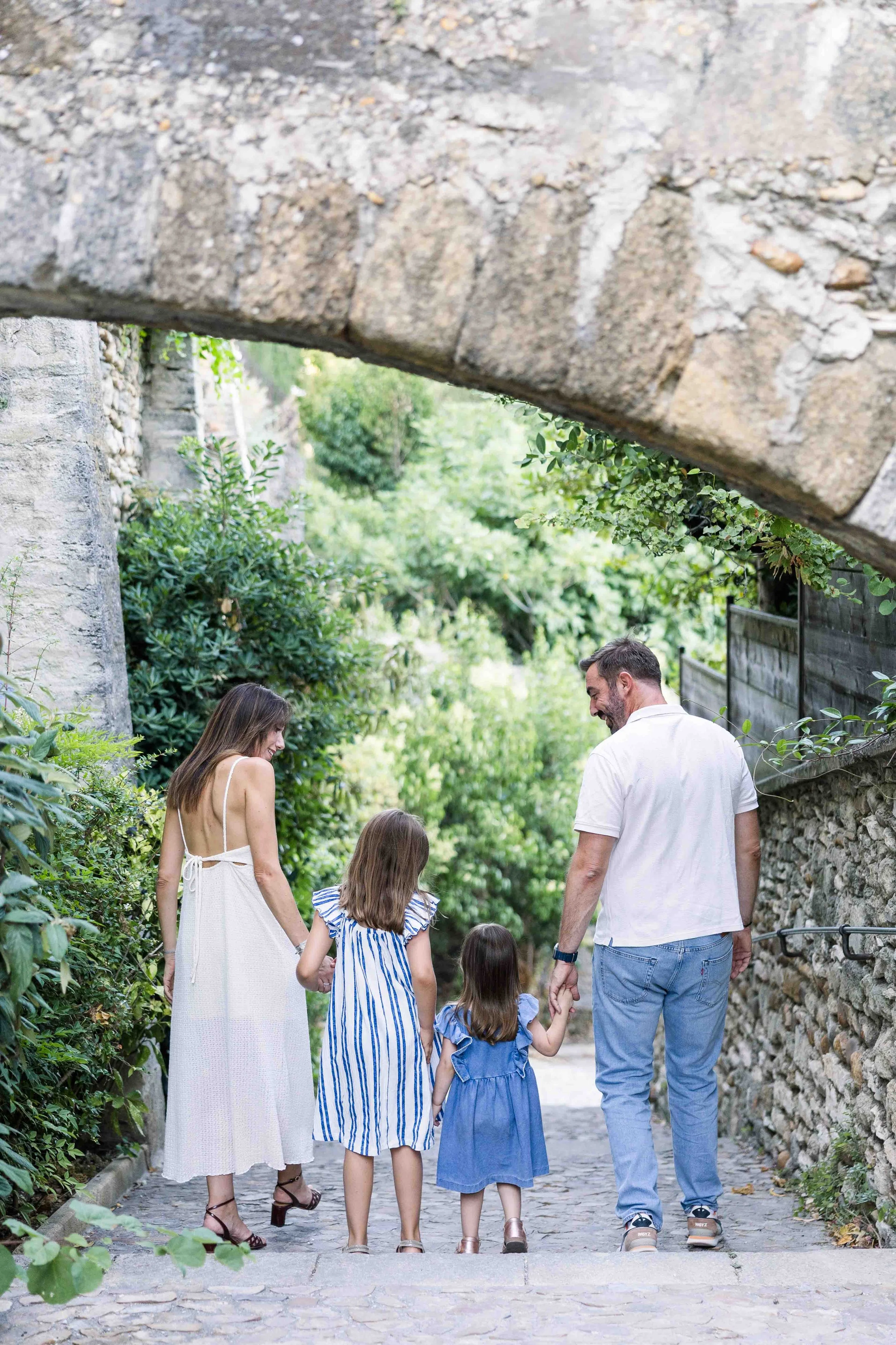 Family Walking Through a Stone Arch