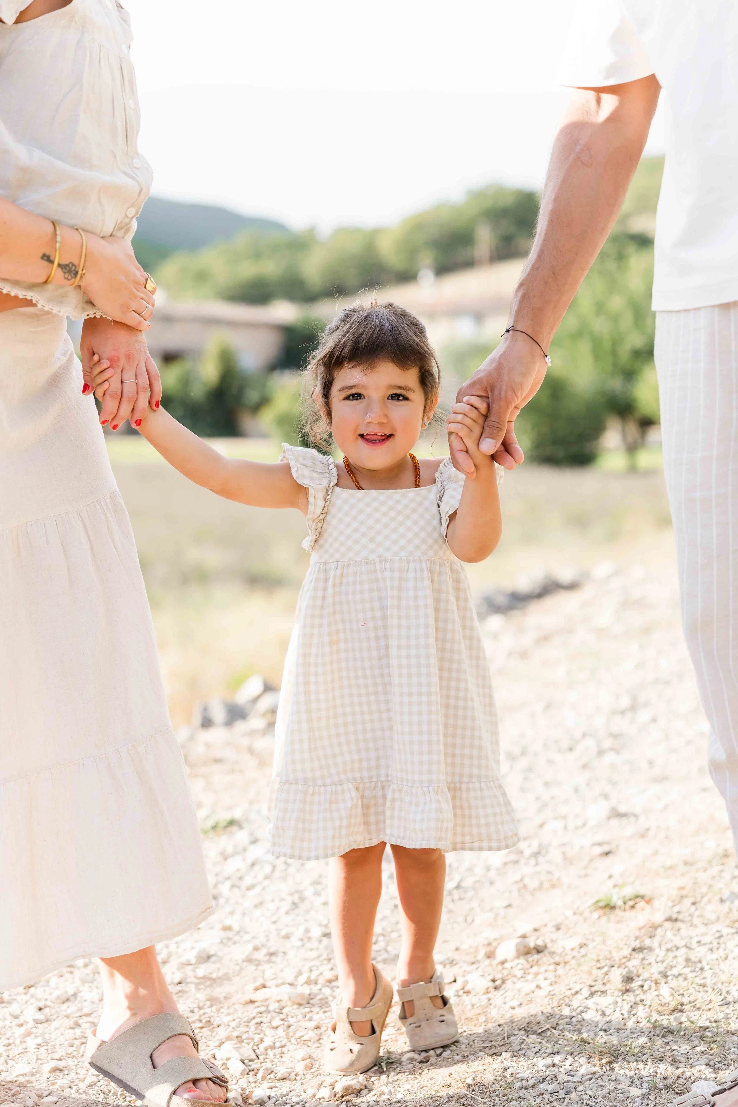 Little girl walking with her parents in Provence