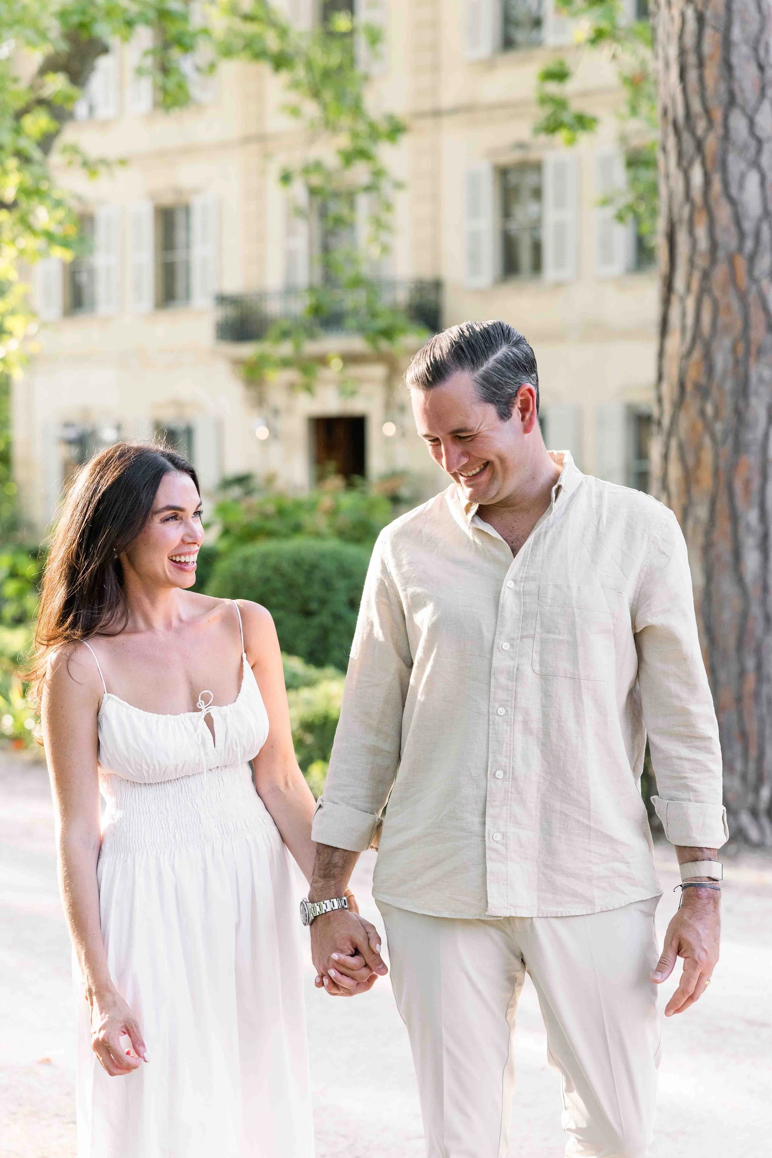 Couple walking through Château des Alpilles gardens