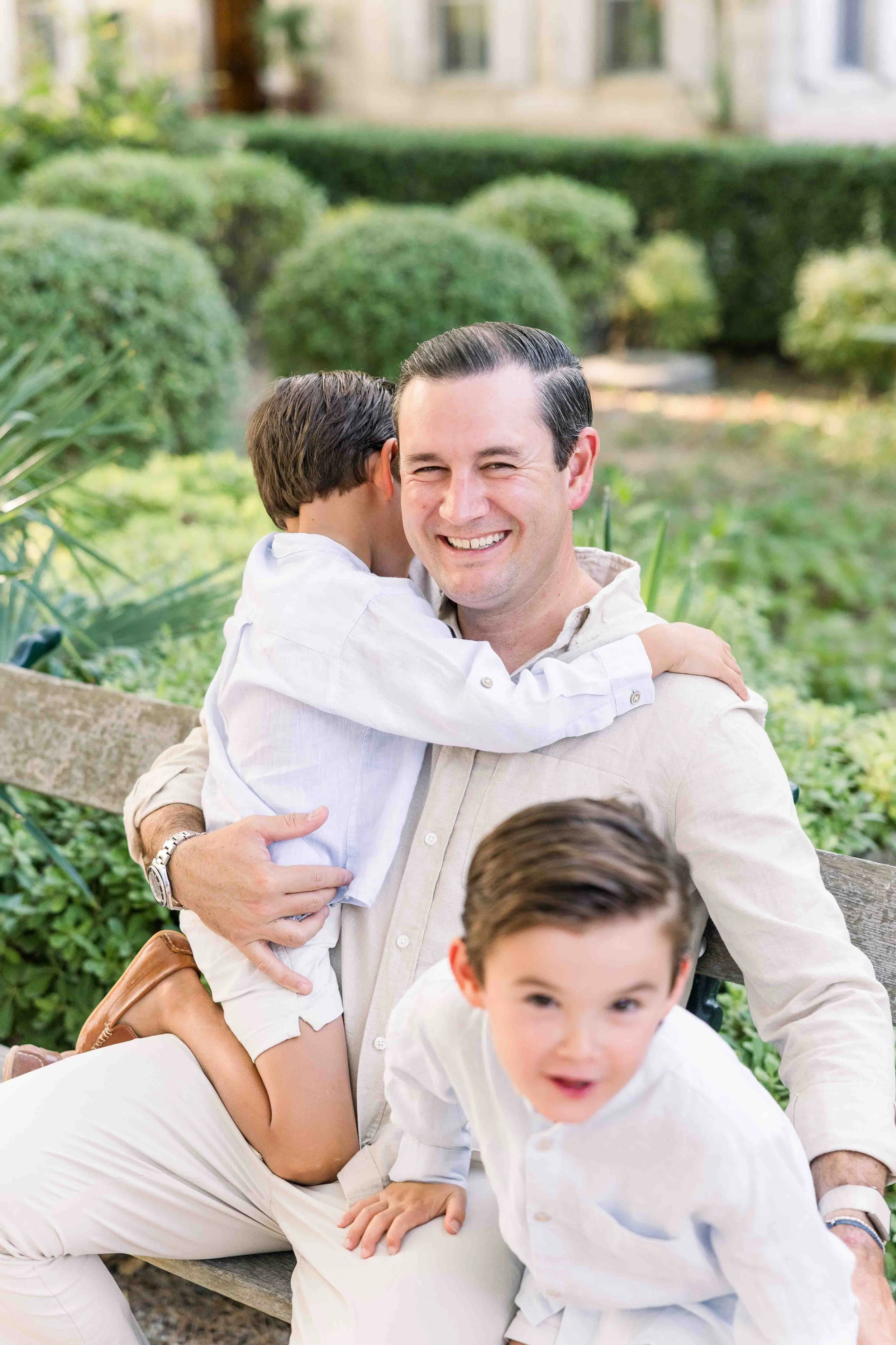 Family sitting together on a garden bench in Provence