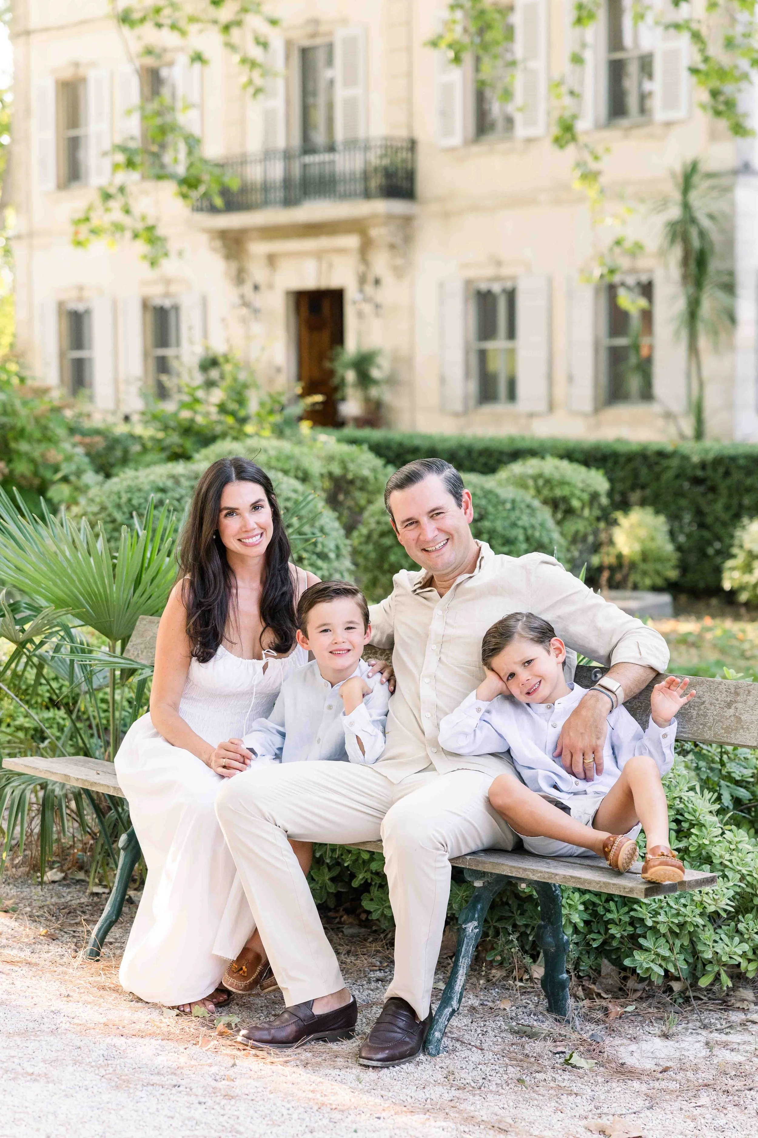 Family sitting together on a garden bench in Provence