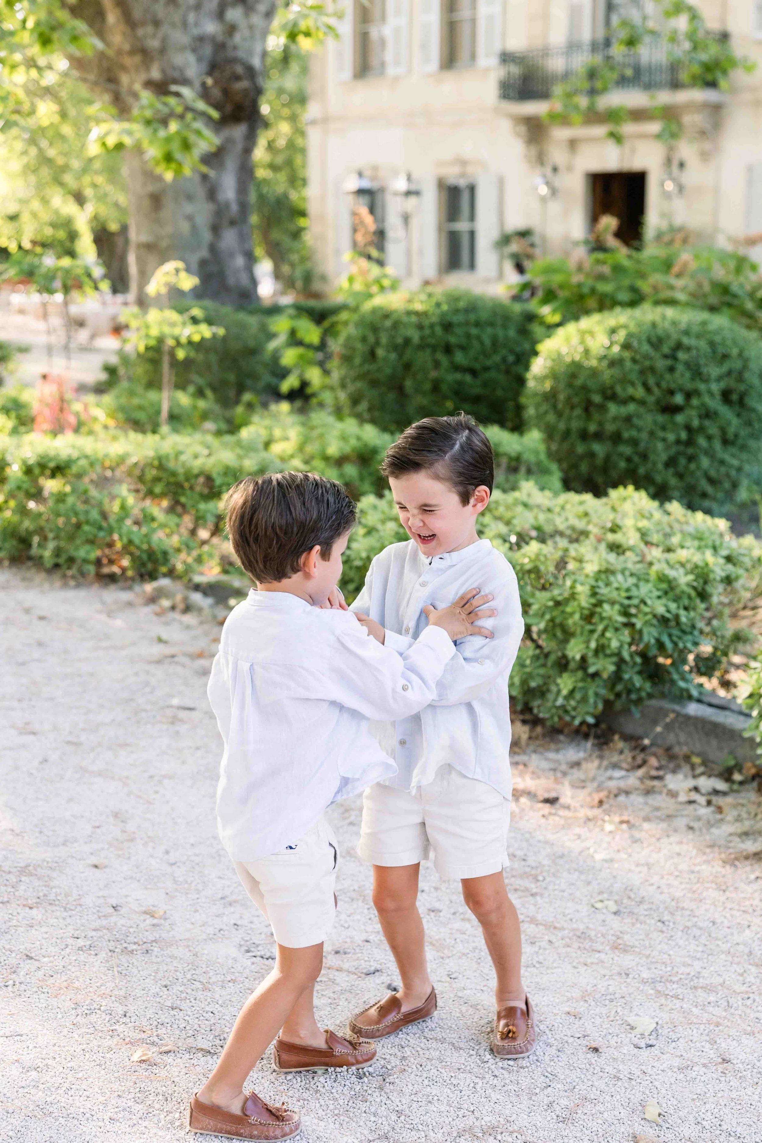 Children laughing in the gardens of Château des Alpilles