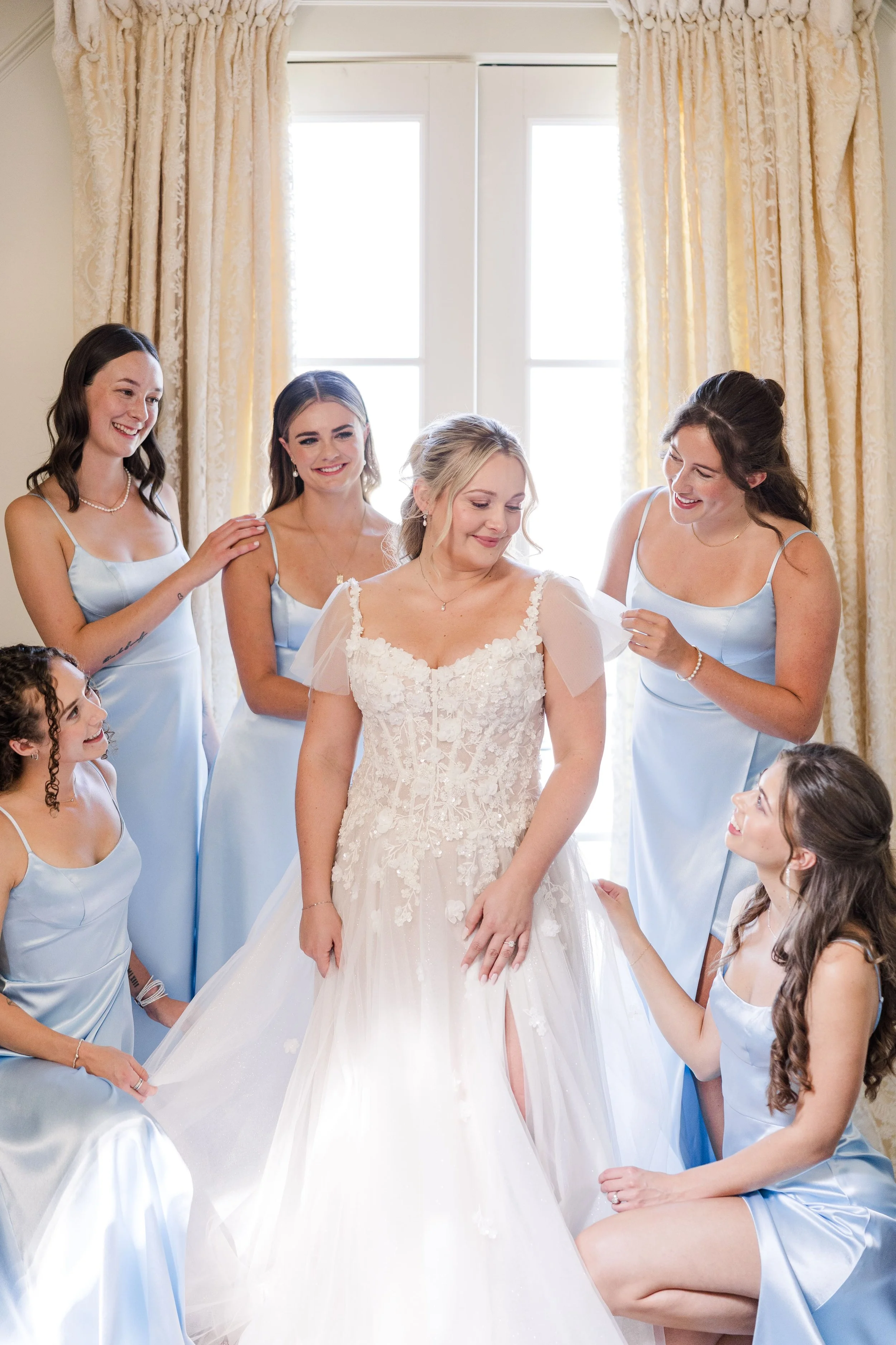 bridal party helping the bride getting in the dress in Provence South of France