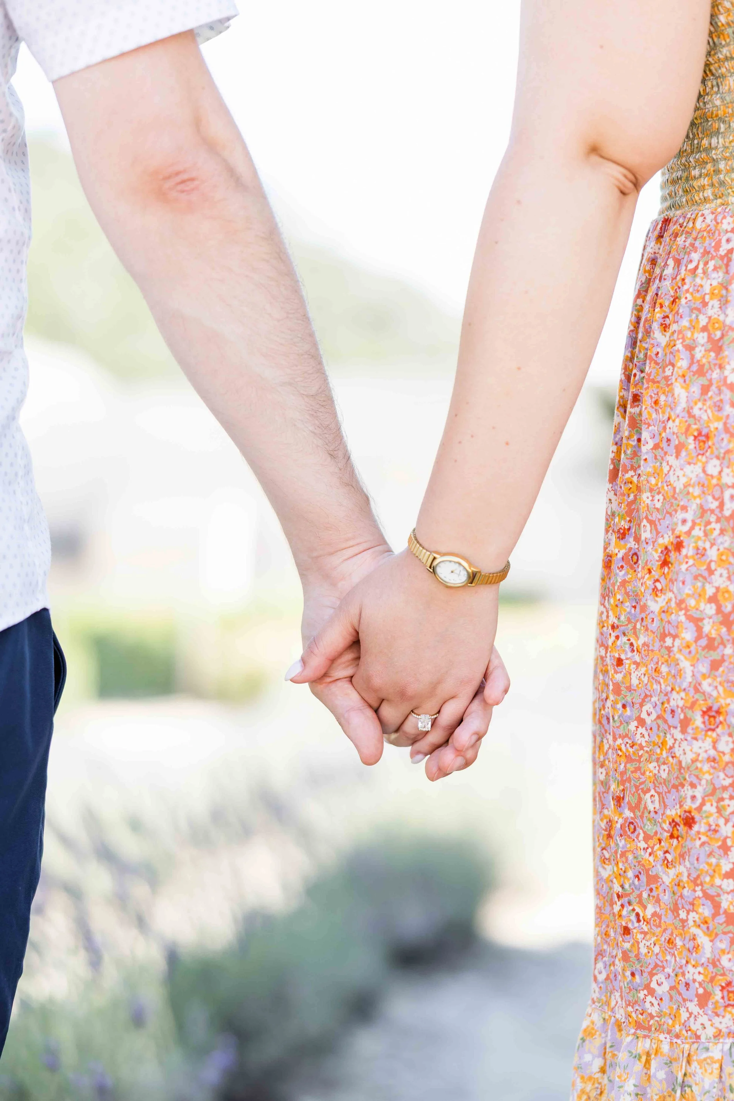 Close-up of a couple holding hands showing the engagement ring after their proposal at Abbaye de Sénanque, Provence