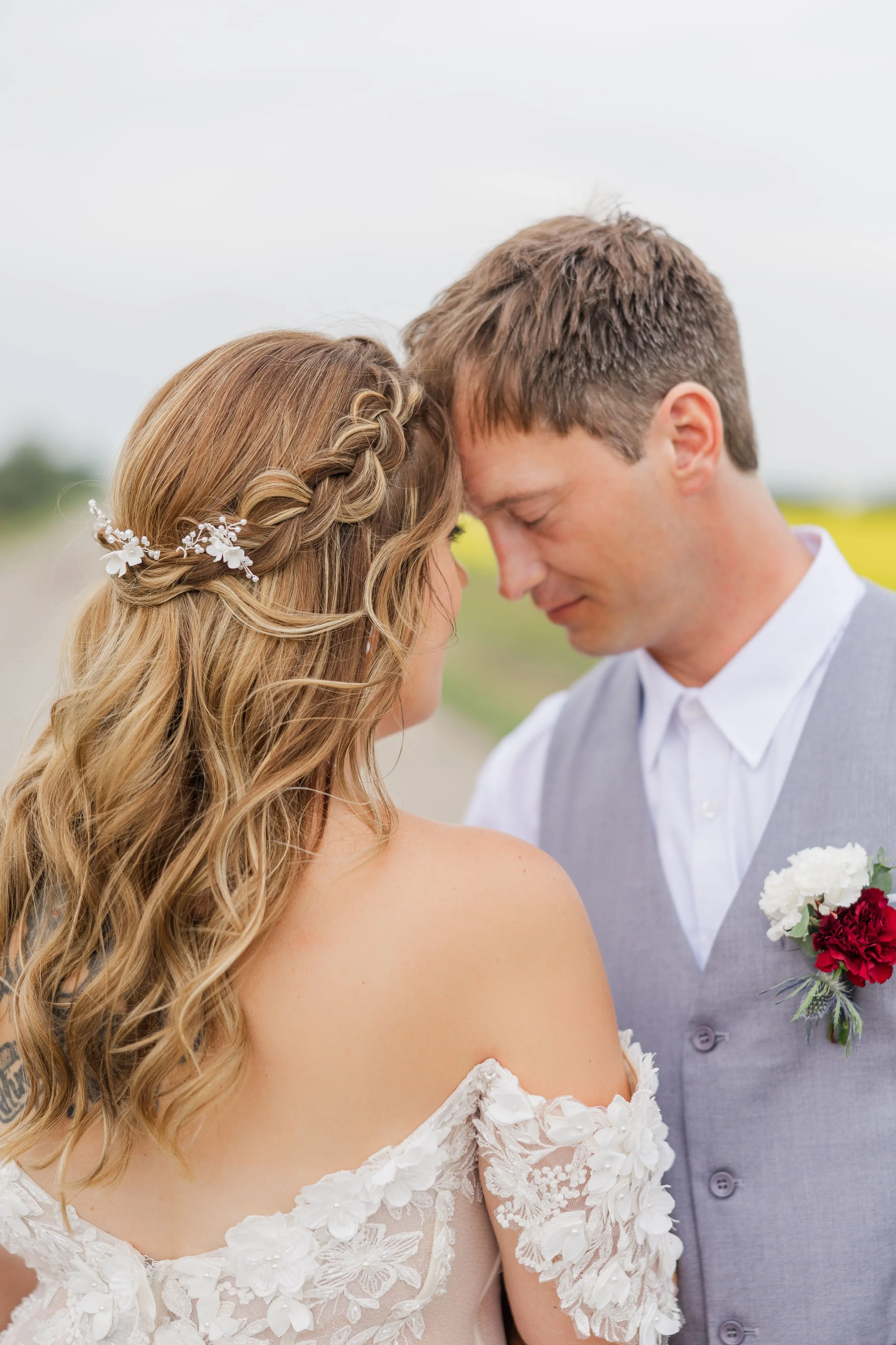 Tender connection as the couple stands forehead to forehead on their wedding day