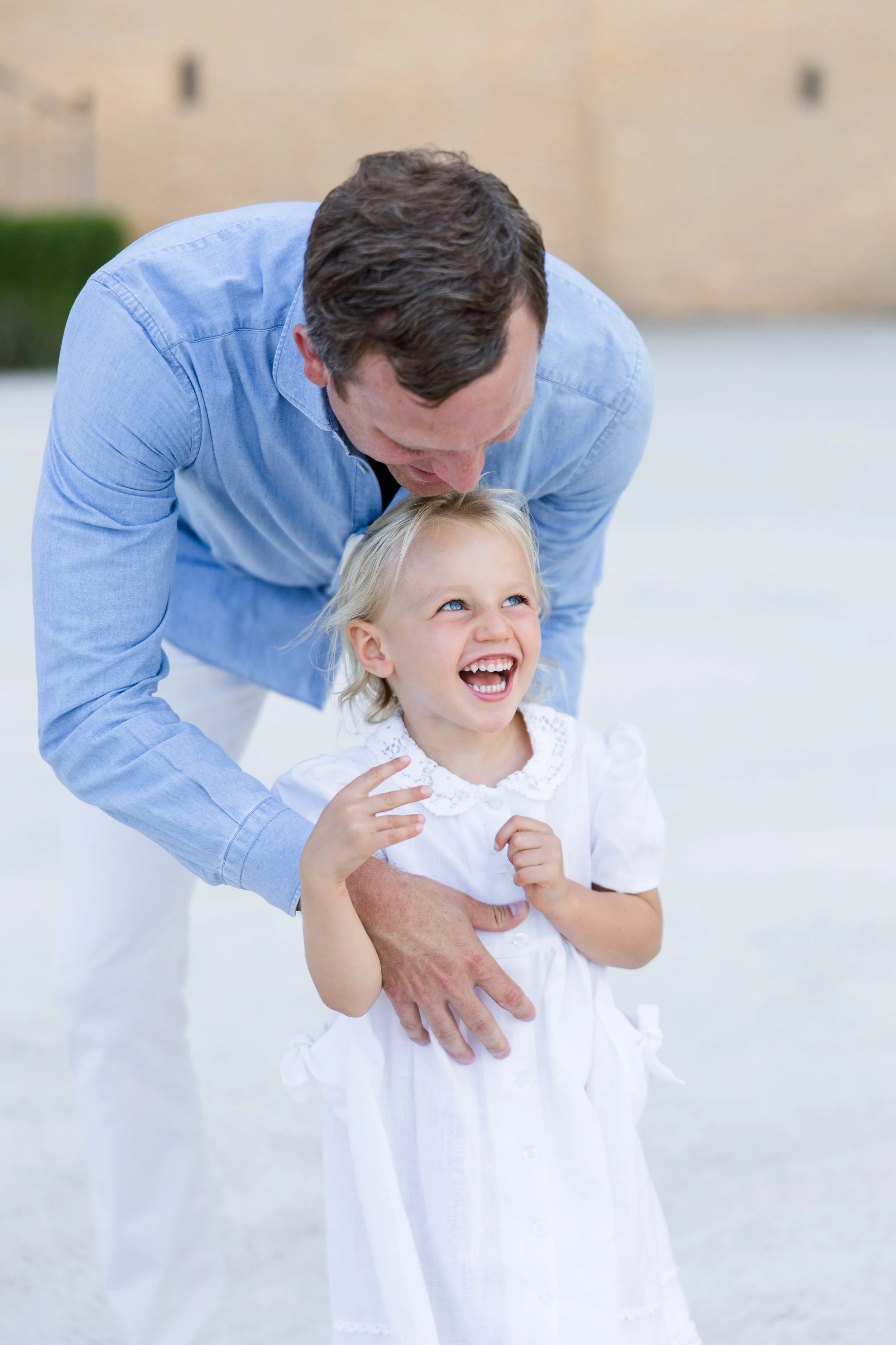 Dad and daughter playing and tickling at chateau de foncscolombe in Provence