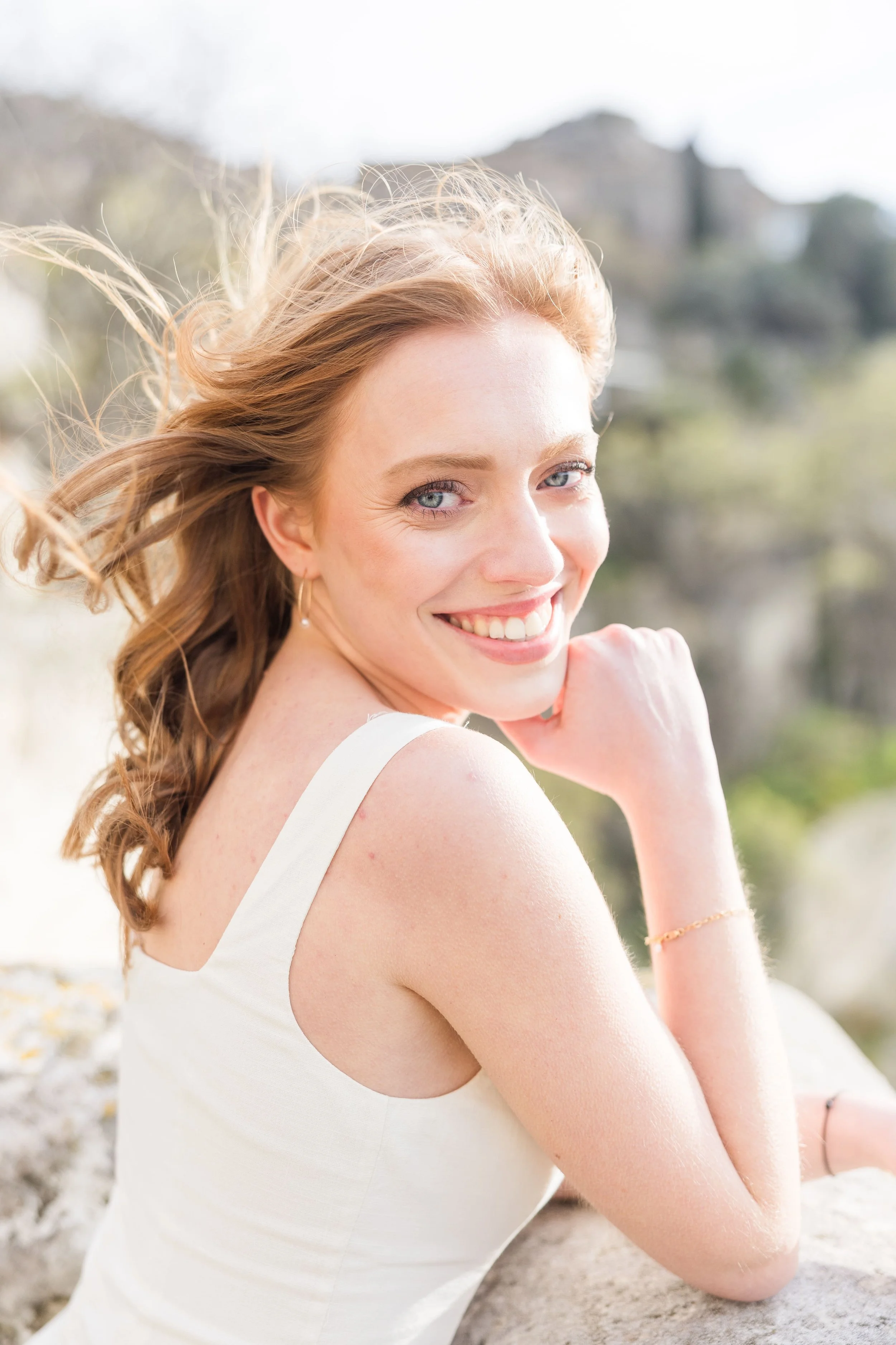 Romantic portrait of a woman in a historic stone alley in southern France