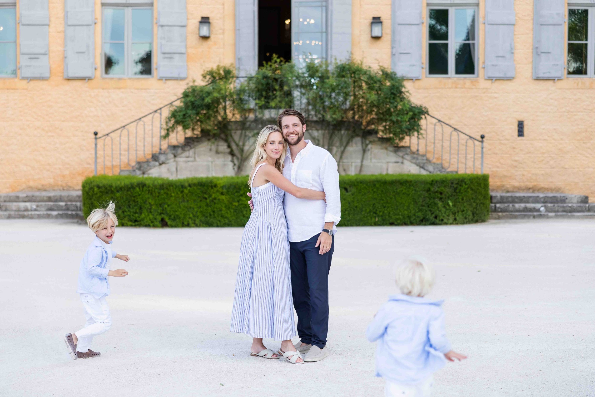 Family from US staying at Chateau fonscolombe smiling at the camera with their boys running around smiling and laughing