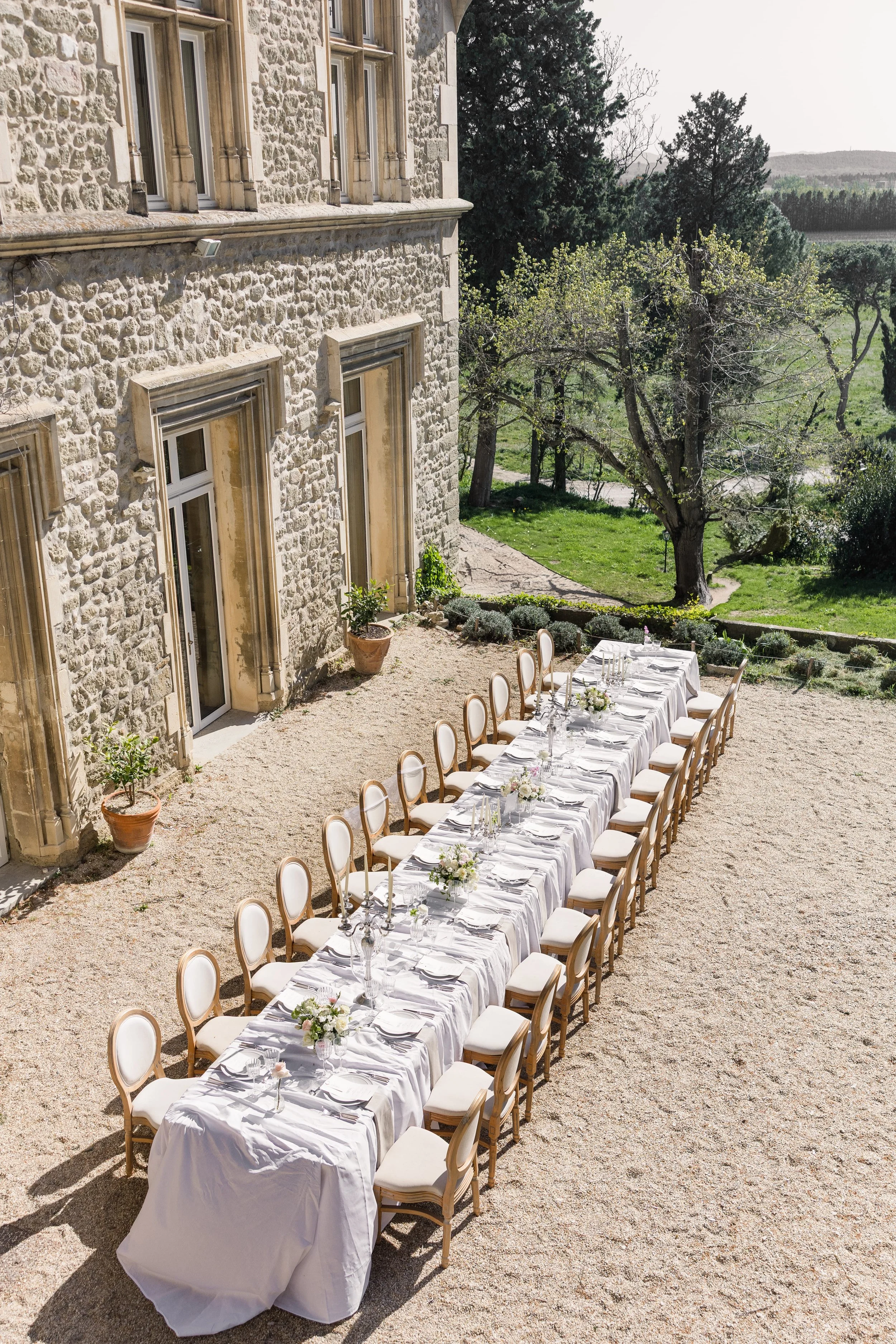 Elegant wedding reception table set in front of Château Saint Laurent in Provence