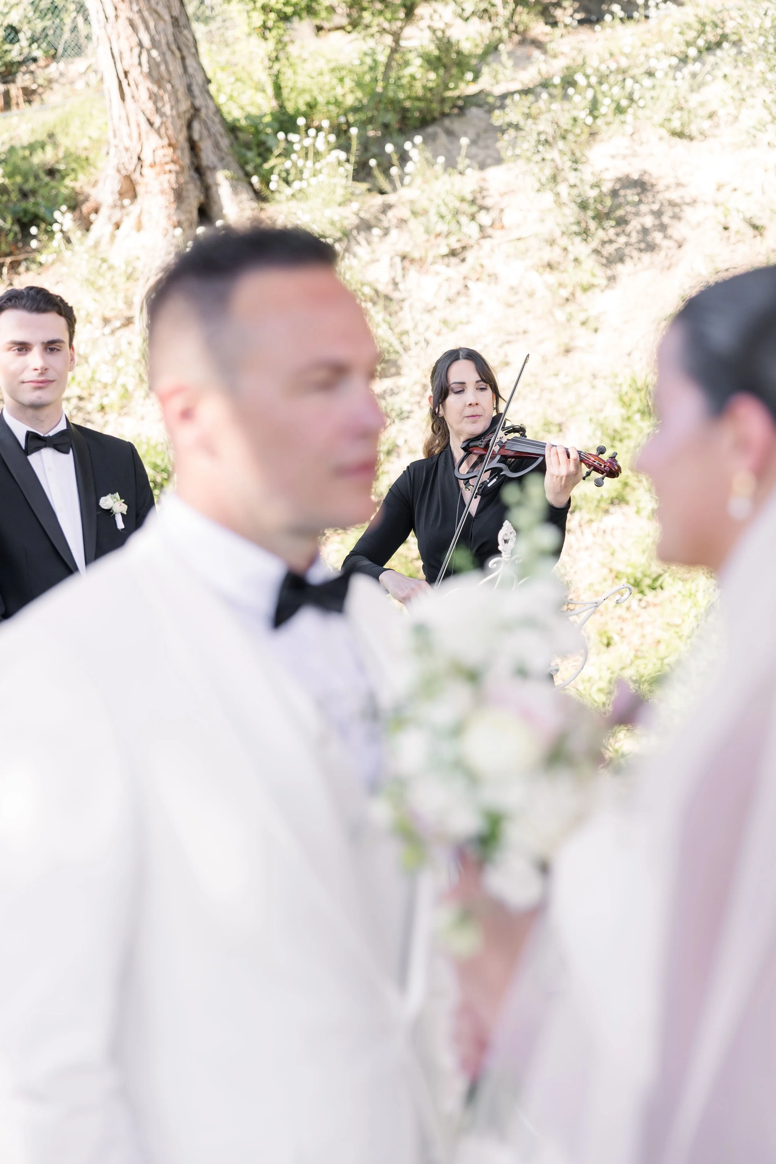 Violinist performing live music during an elegant wedding ceremony
