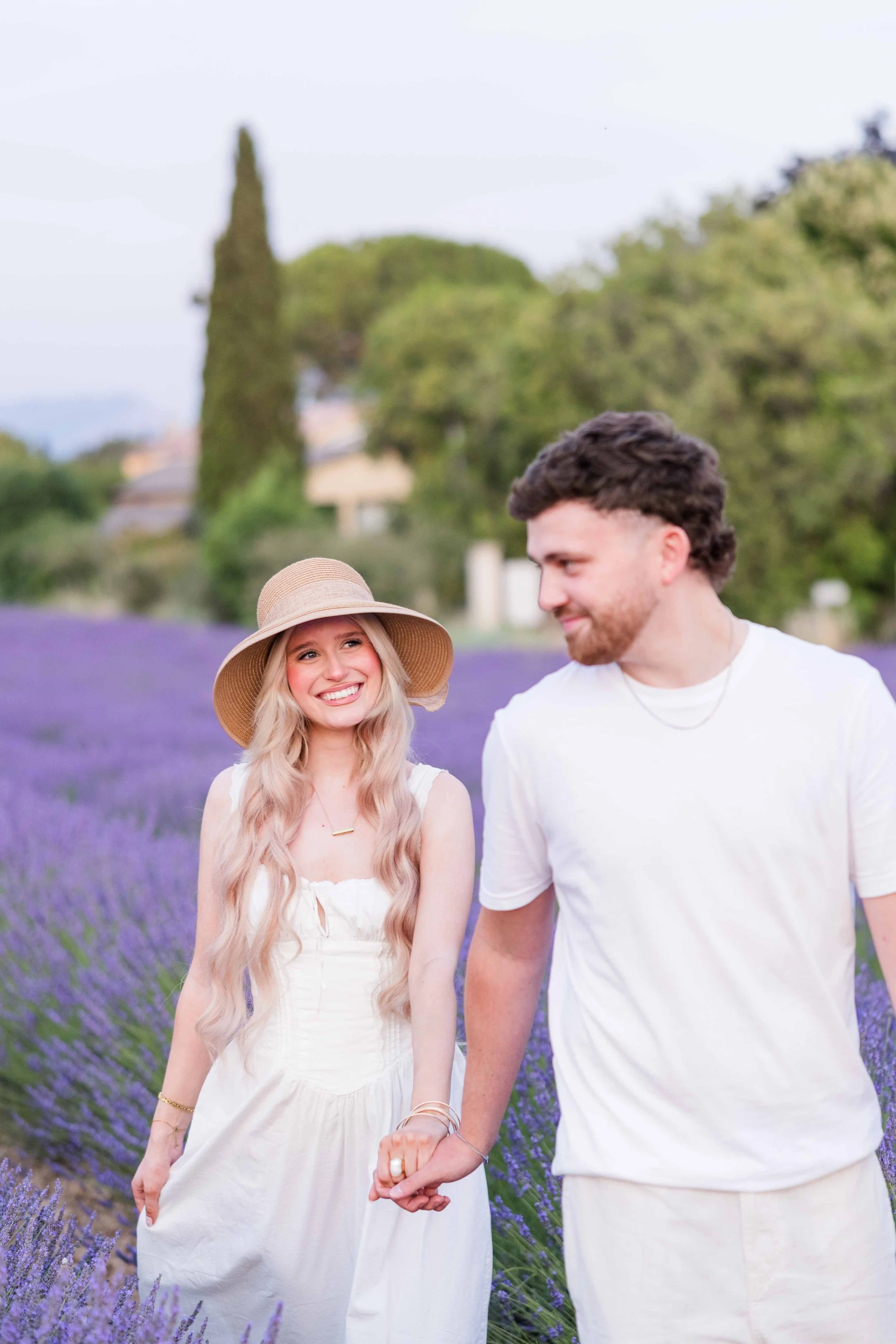 Portait of a couple walking in a lavender field close to aix en provence during their stay in Provence
