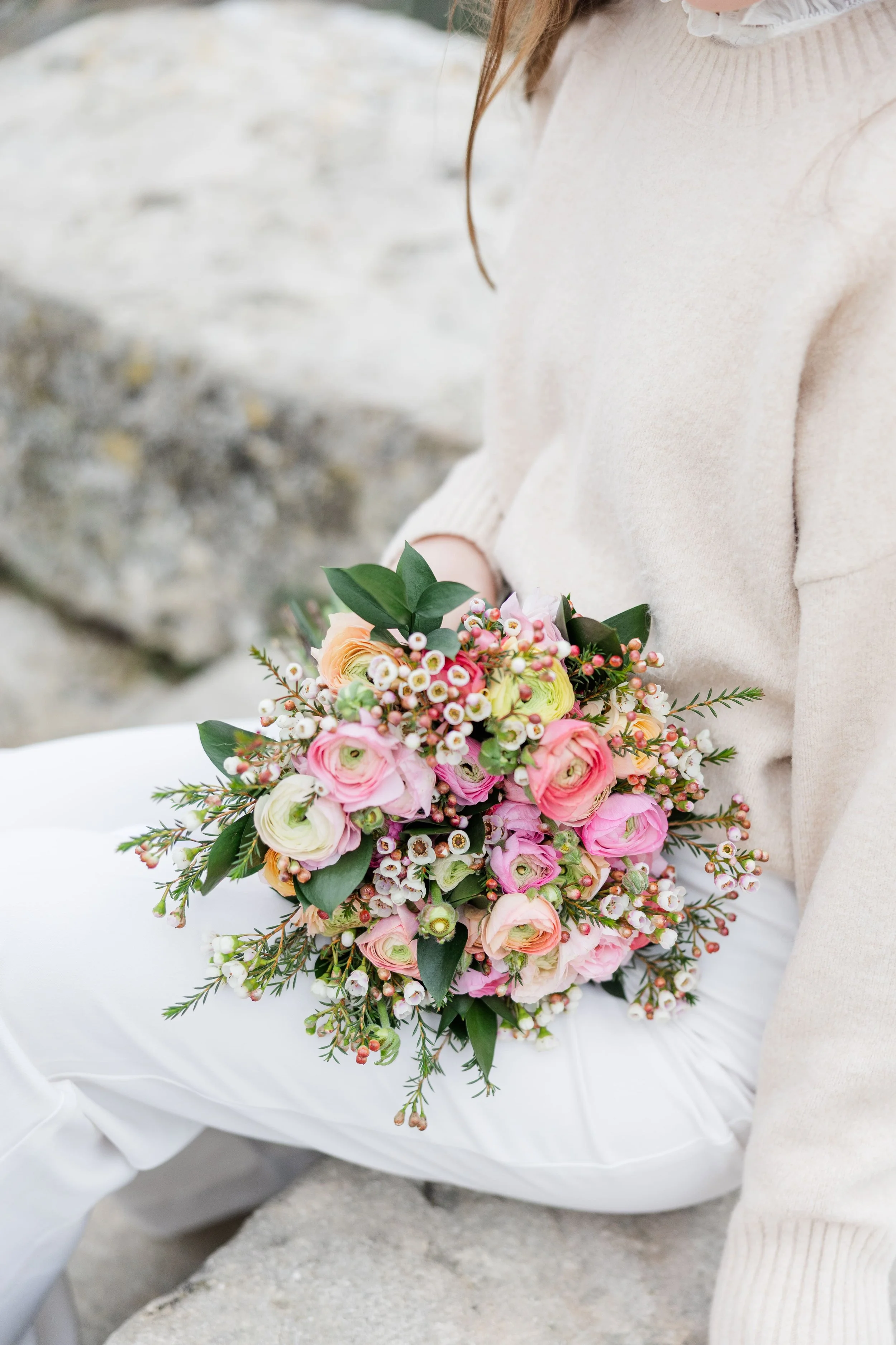 Woman in a flowing dress surrounded by pink flowers in Gordes, Provence