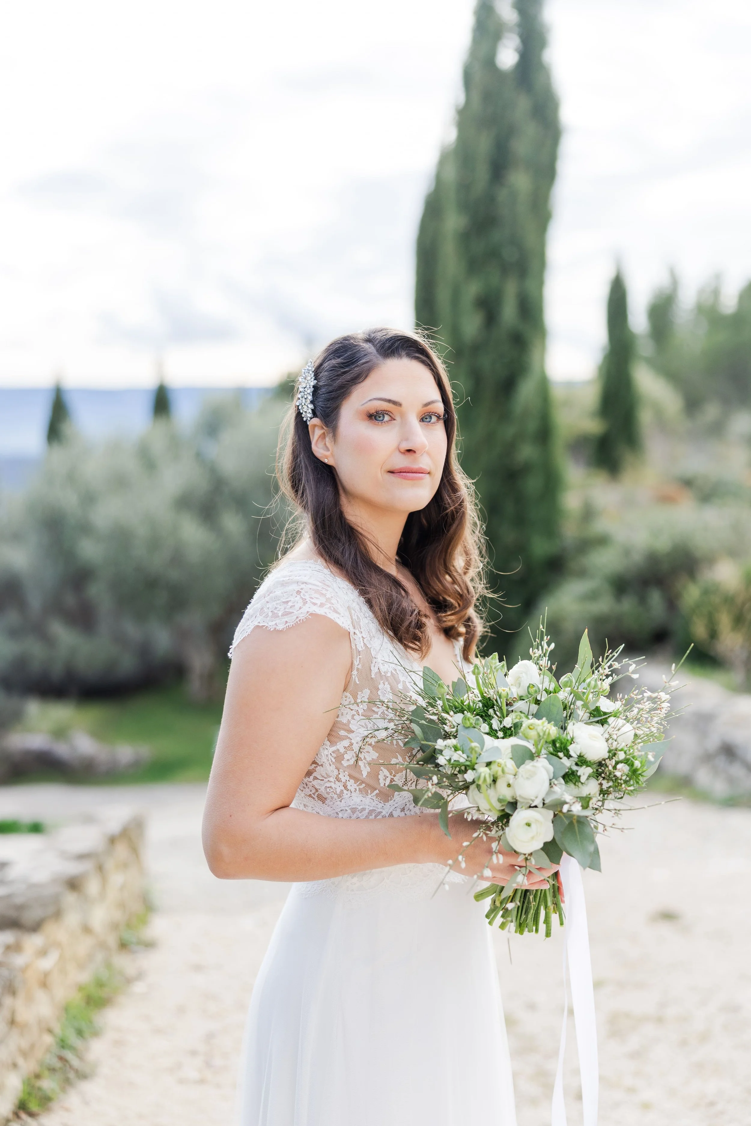 Bridal portrait in Gordes holding her flowers