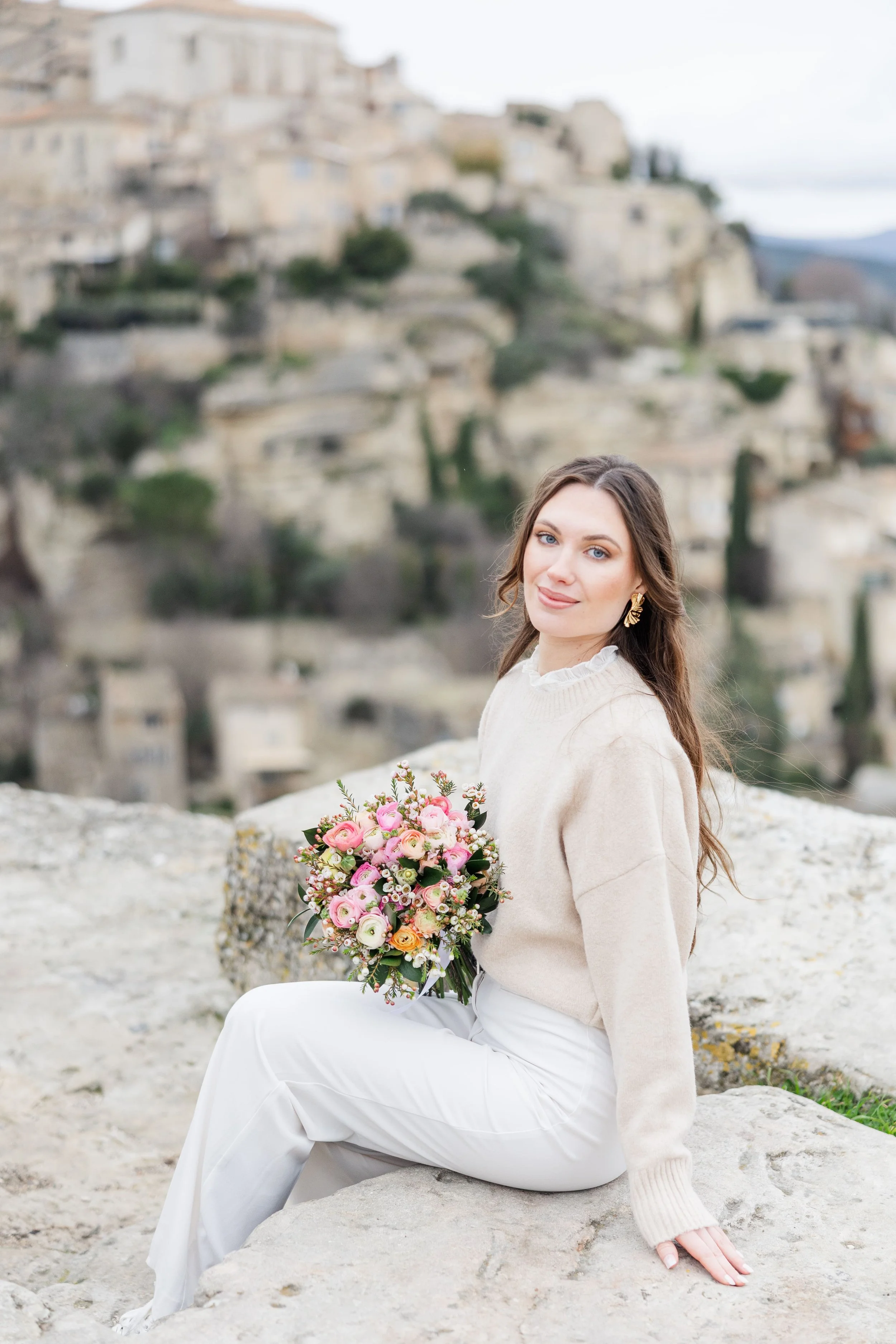 Soft and romantic solo portrait with pink blossoms in Gordes, France