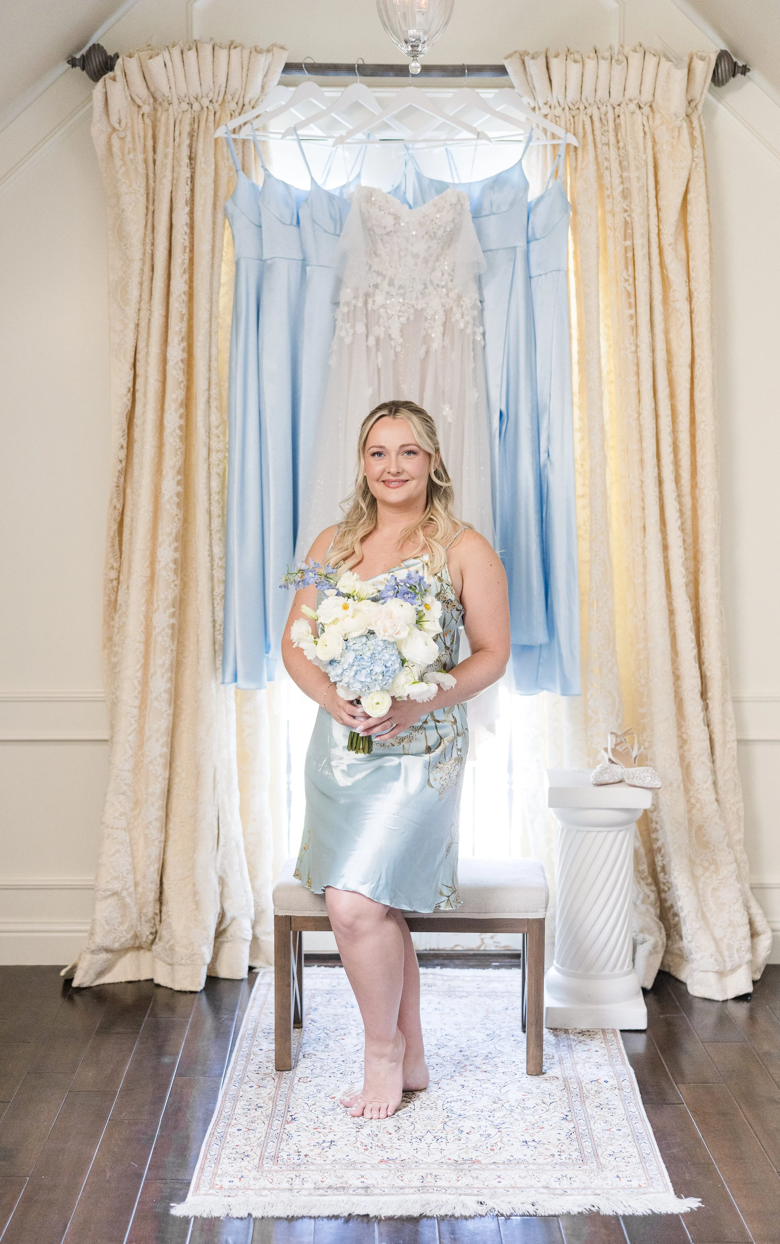 bridal portrait with her flowers just before getting in the dress