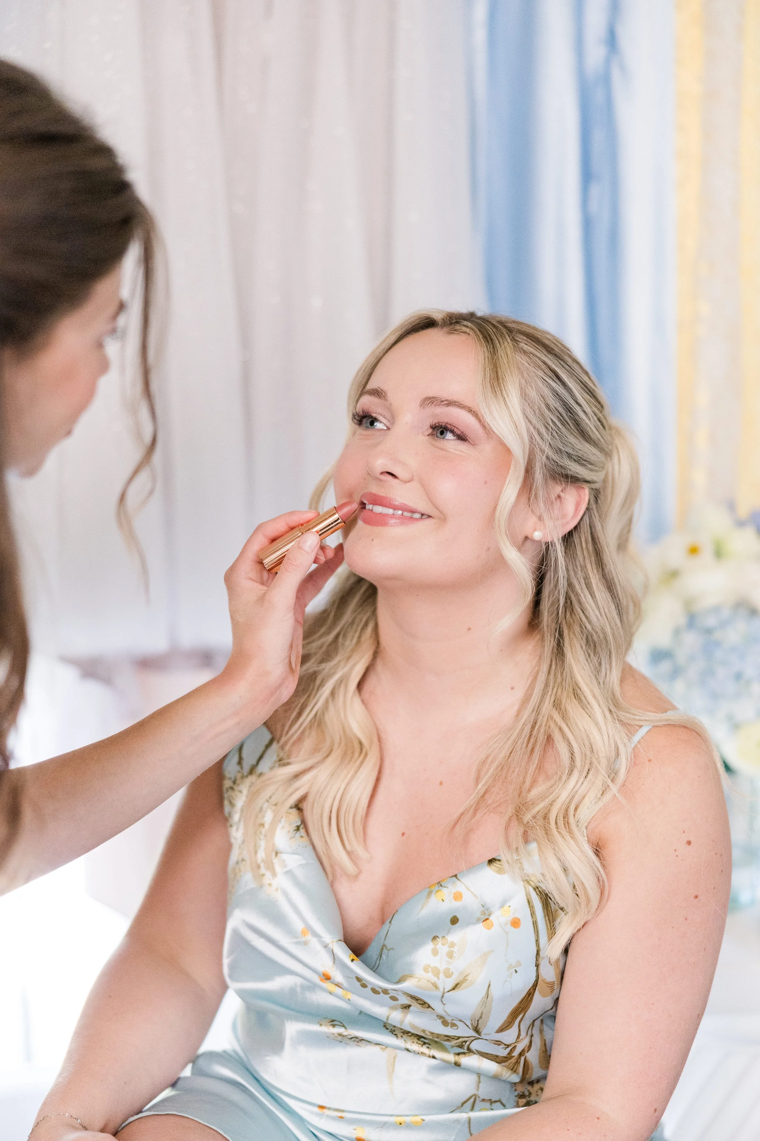 Bridal party getting ready in their dress with the brides and florals in the getting ready room in Provence